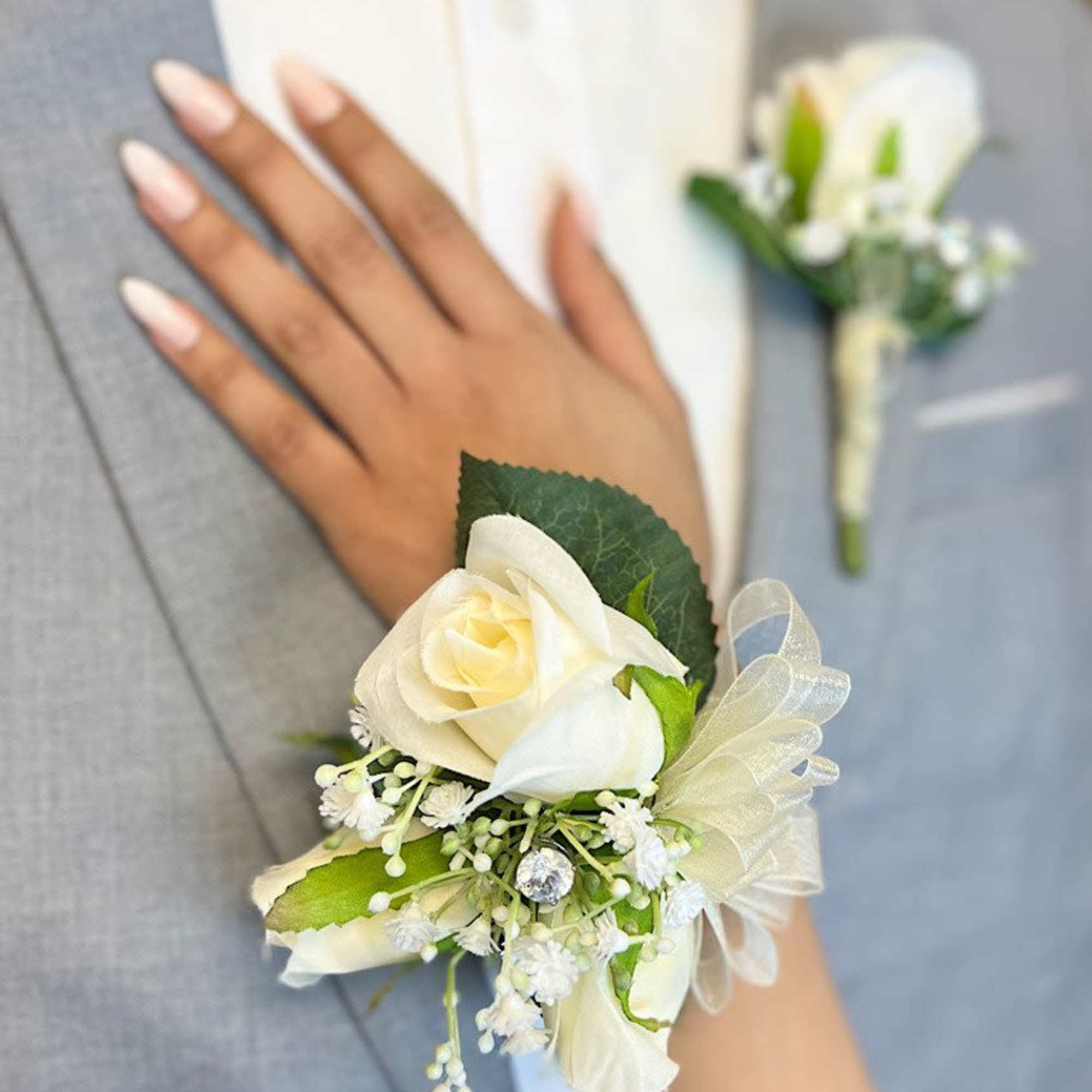 A corsage is a small floral arrangement typically worn around the wrist A corsage is a small floral arrangement typically worn around the wrist