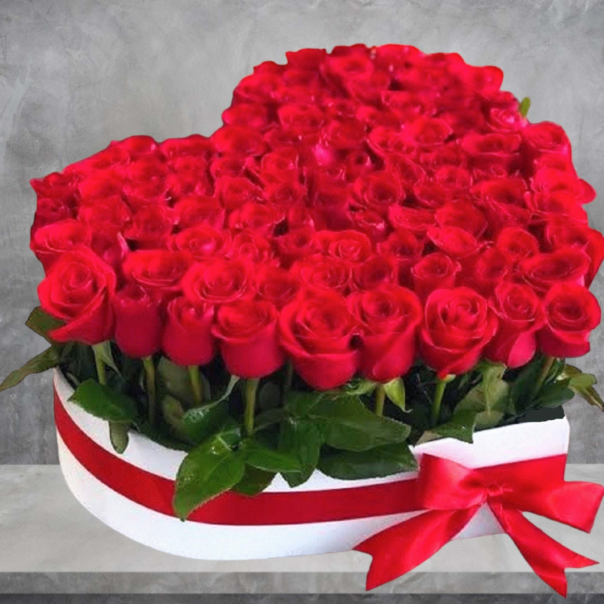 A modern flower arrangement in a heart box filled with roses.

DETAILS
This heart