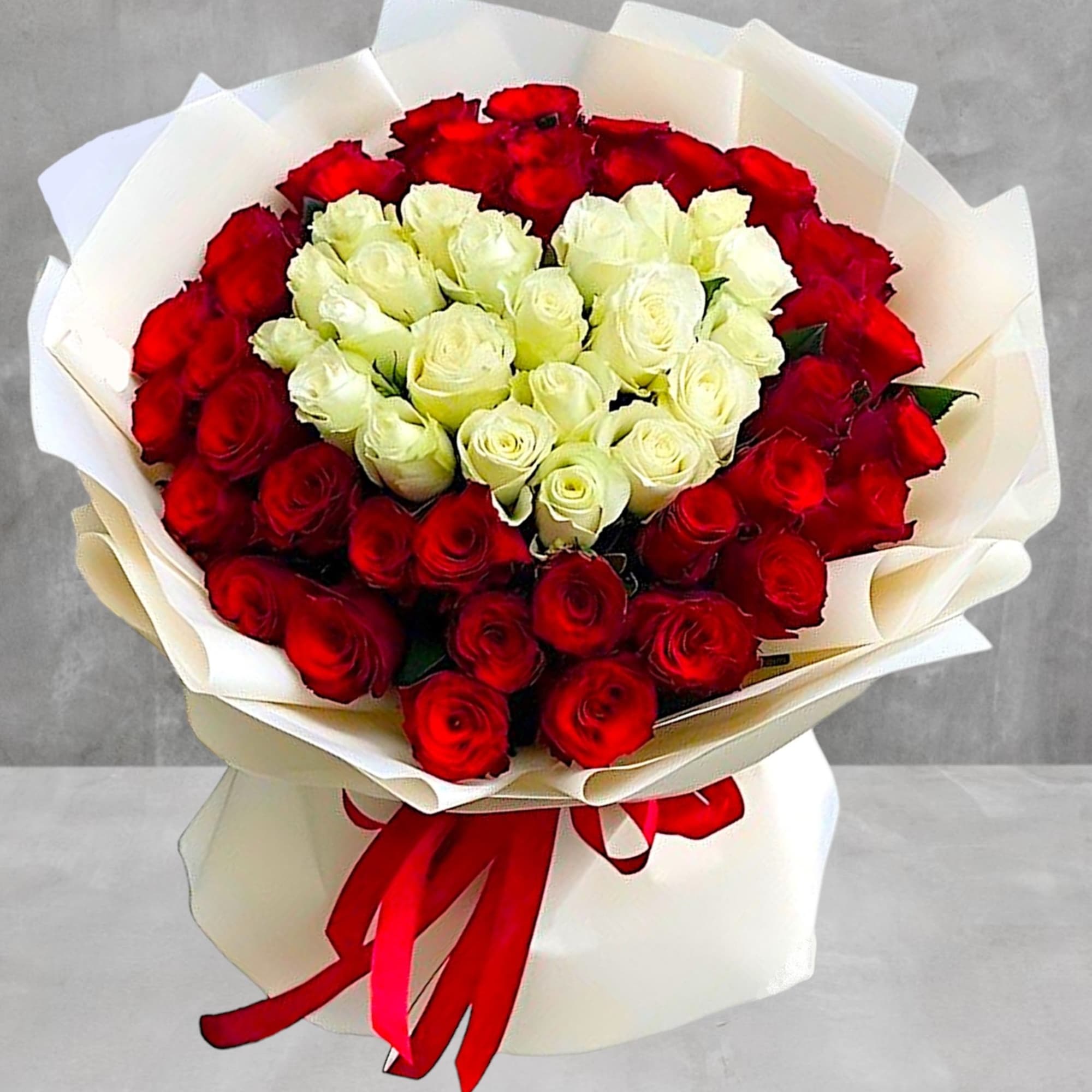 Surprise them with a beautiful bunch of red and white roses to
