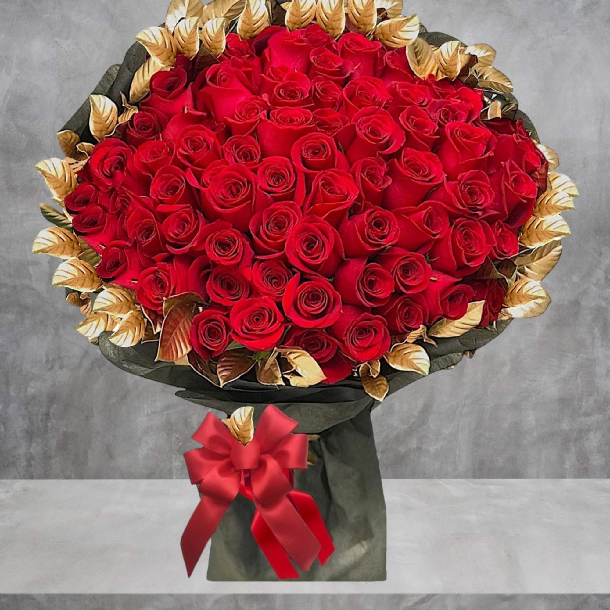 Surprise them with a beautiful bouquet of red roses and gold painted