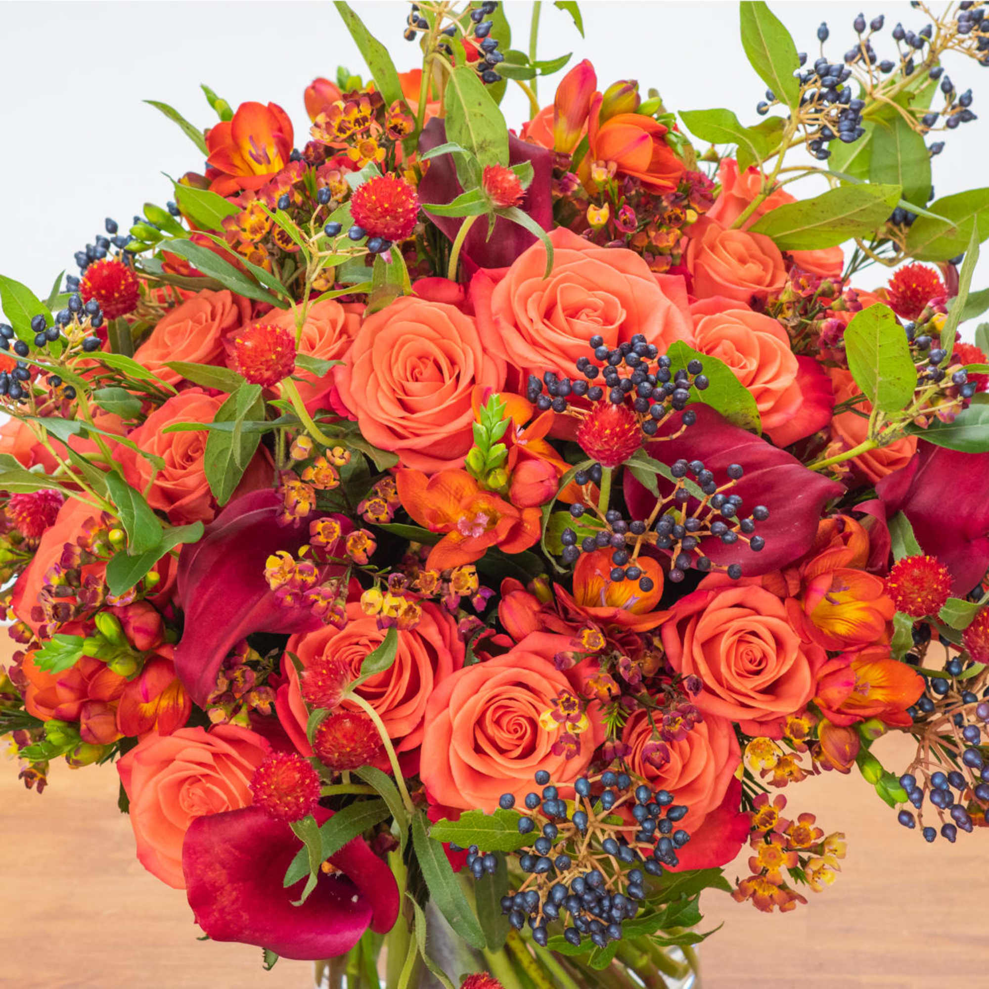 Beautiful fall floral arrangement with fall colors made with roses, mini calla