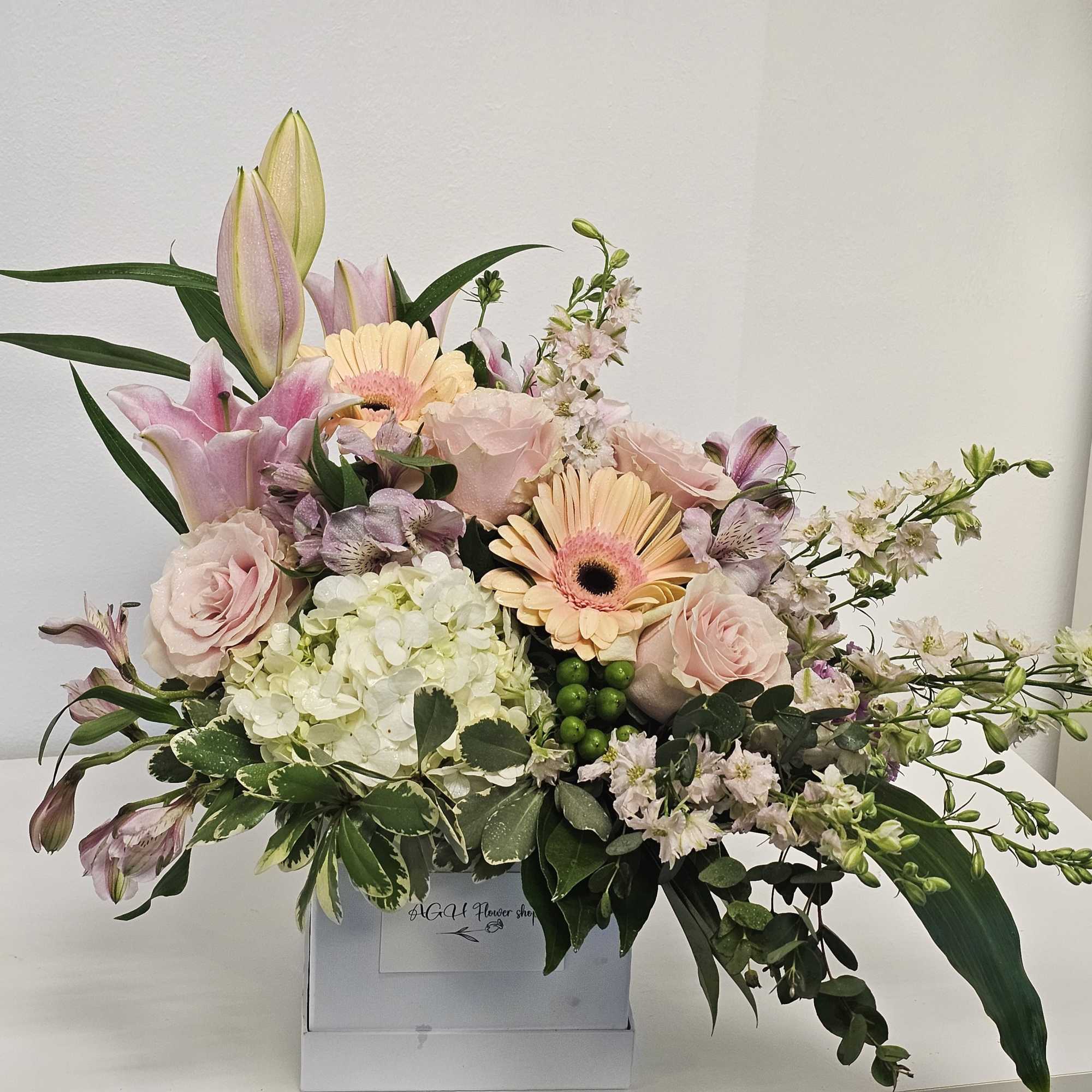 Our Delicate Sympathy Arrangement gracefully combines soft, pastel blooms, offering a gentle