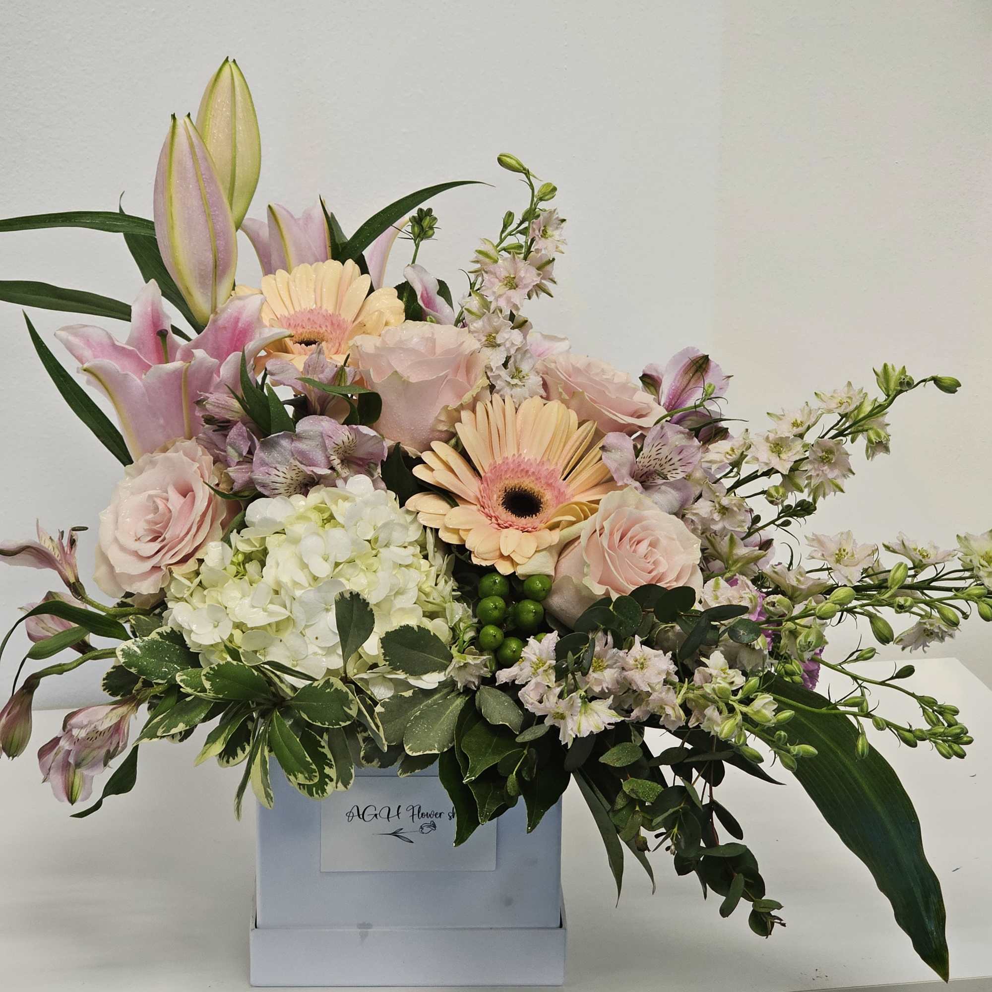 Our Delicate Sympathy Arrangement gracefully combines soft, pastel blooms, offering a gentle