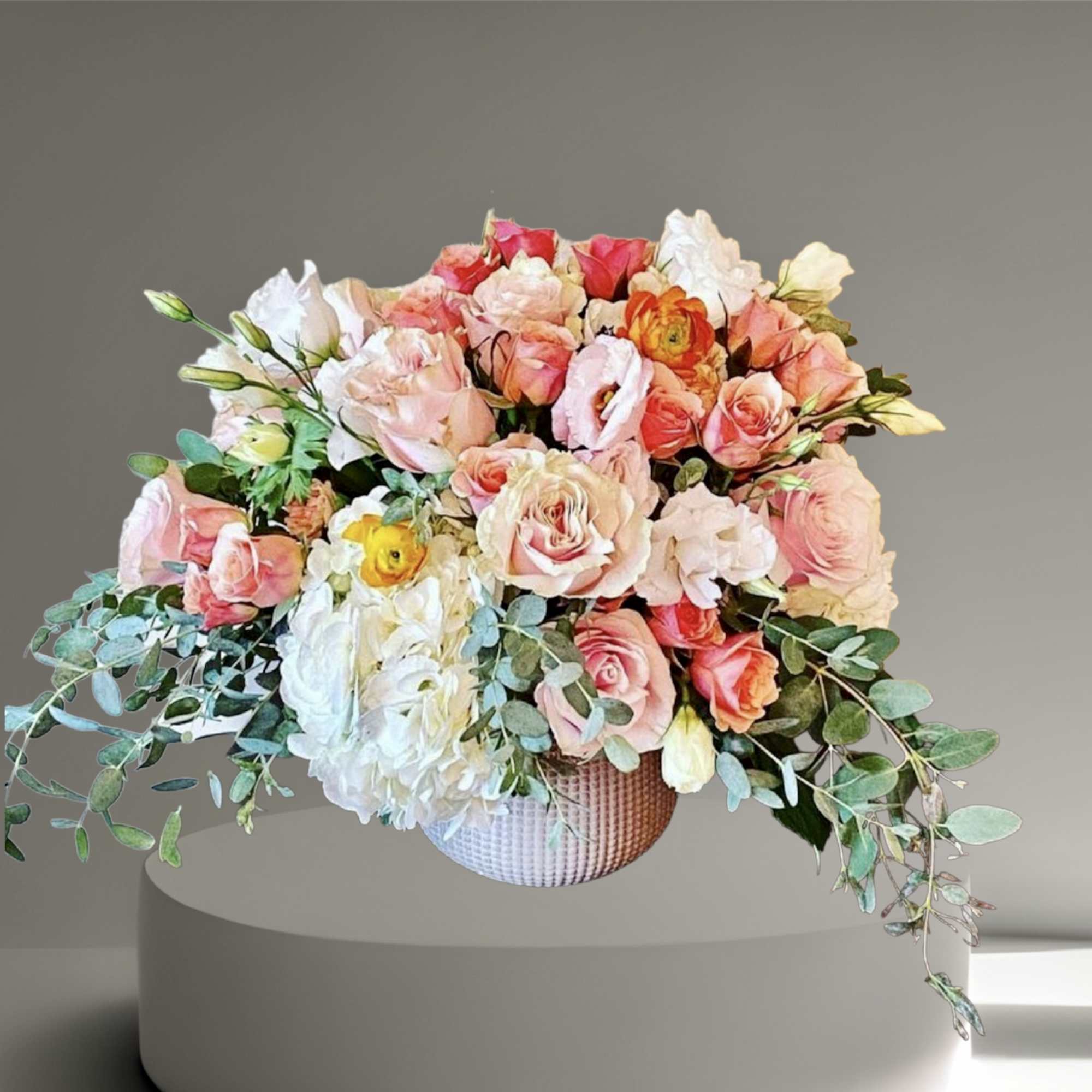 A sweet mix of pastel roses, ranunculus, lisianthus, hydrangea and eucalyptus in