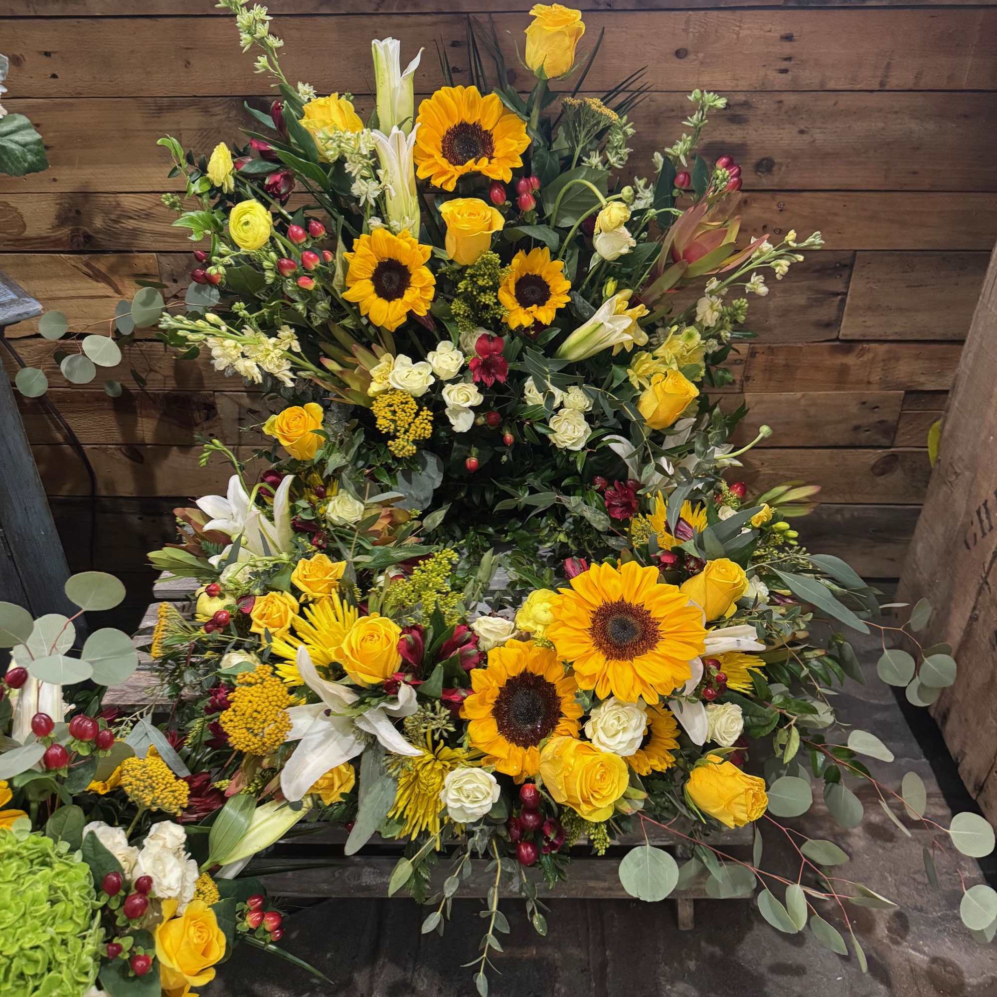 This beautiful arrangement contains various yellow flowers, like sunflowers, roses, spray roses