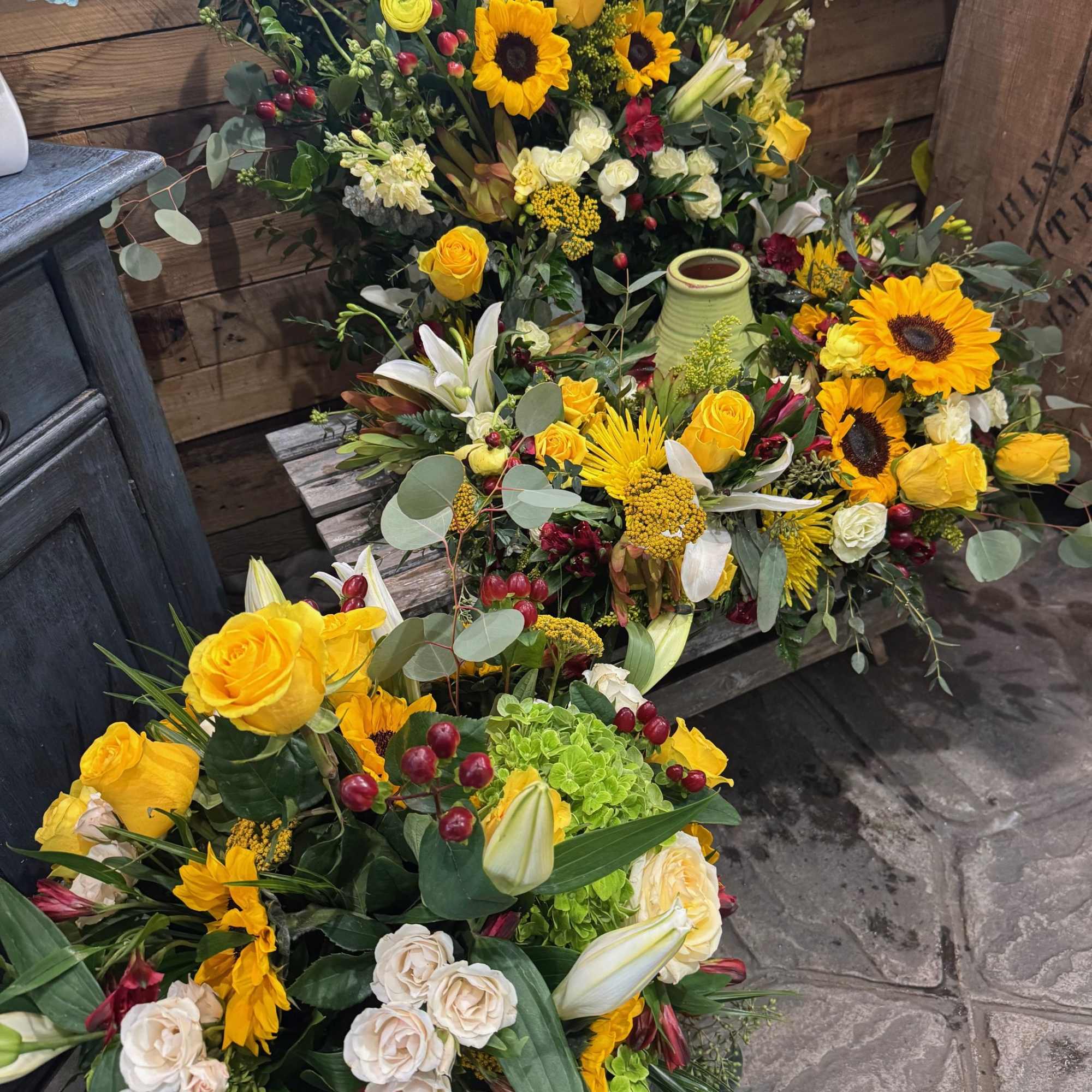 This beautiful arrangement contains various yellow flowers, like sunflowers, roses, spray roses