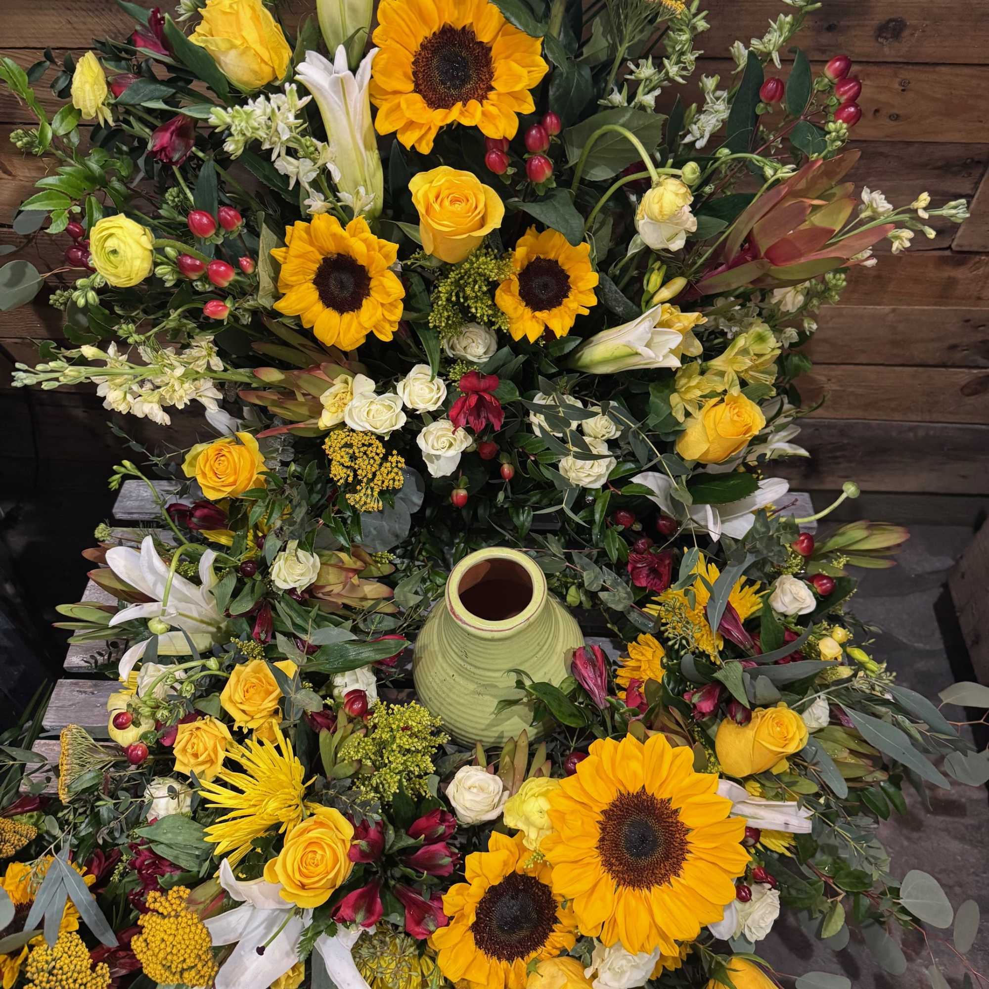 This beautiful arrangement contains various yellow flowers, like sunflowers, roses, spray roses