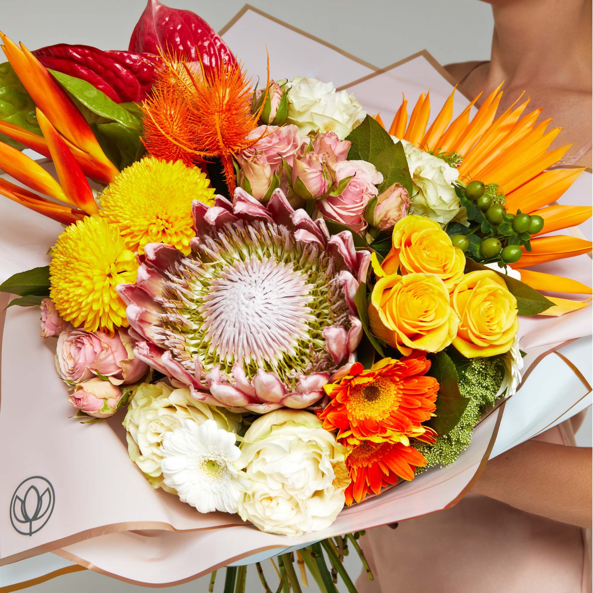 Tropical and exotic flower bouquet with King protea, roses, laceleafs and transvaal Tropical and exotic flower bouquet with King protea, roses, laceleafs and transvaal