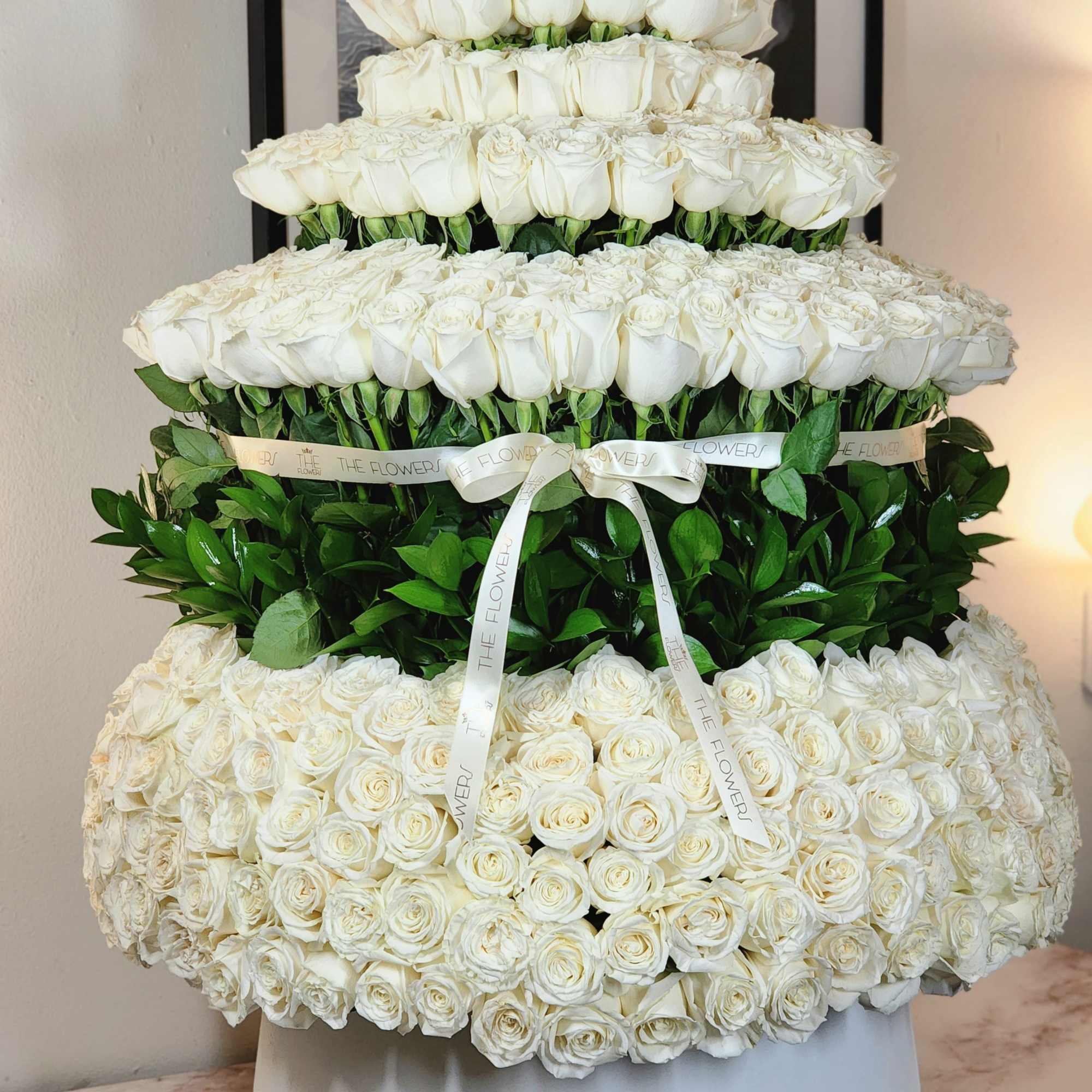 A breathtaking display of 500 roses arranged in a towering masterpiece, reminiscent