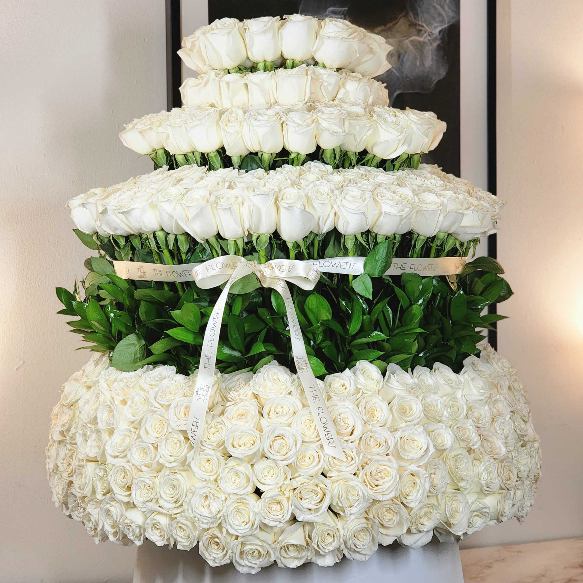 A breathtaking display of 500 roses arranged in a towering masterpiece, reminiscent