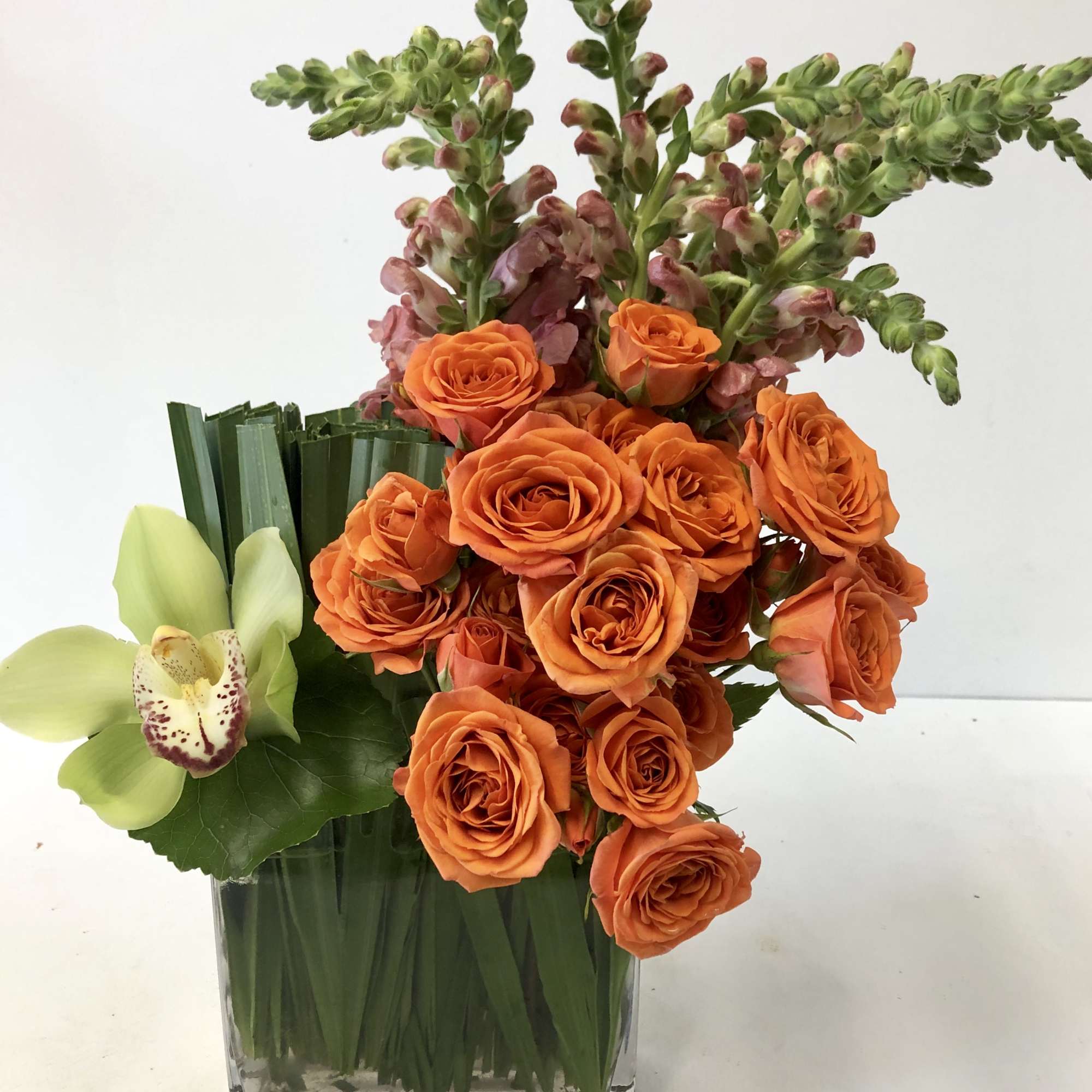 Great movement arrangement, with flair. Orange Snap Dragons, Orange Spray Roses, Palmetto Great movement arrangement, with flair. Orange Snap Dragons, Orange Spray Roses, Palmetto