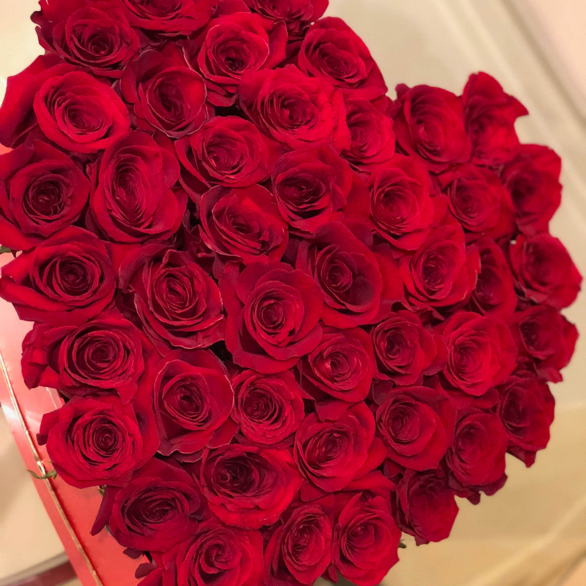 There are about 40-50 red roses in this arrangement. 
 
Please note