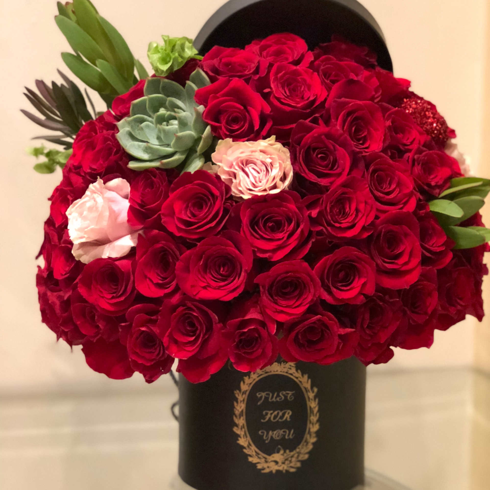 Just for You by Laazati

There are about 40-50 roses in this arrangement.