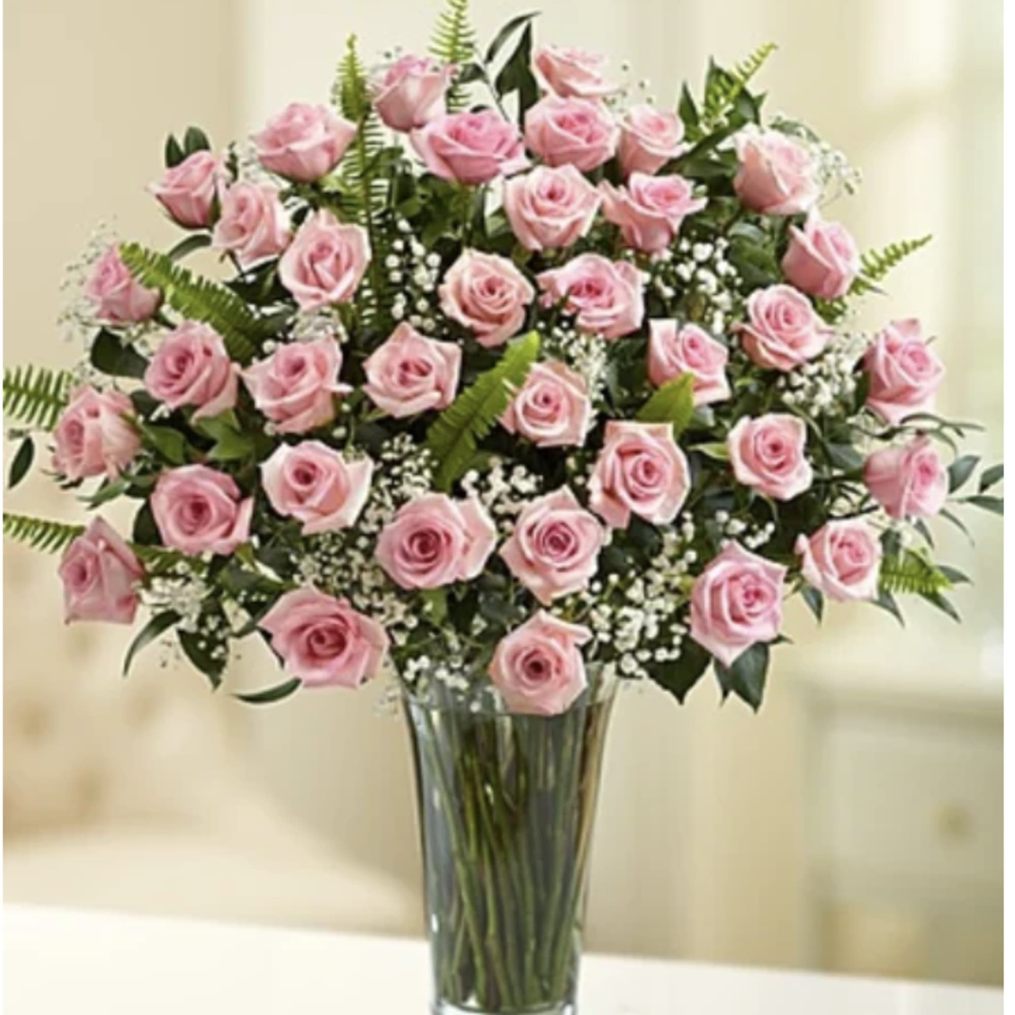 A dozen gorgeous pink roses are the perfect romantic gift to send