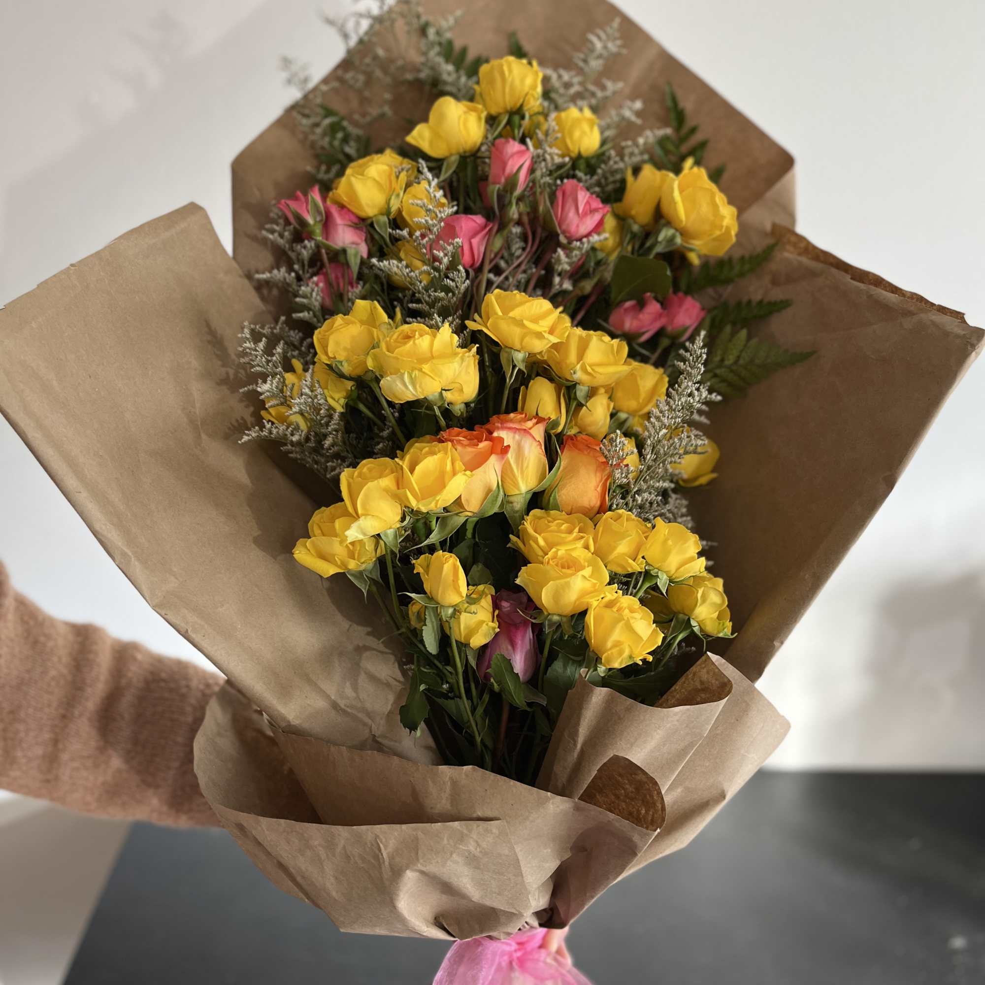 Wrapped Spray Rose bouquet with yellow spray roses, pops of pink and