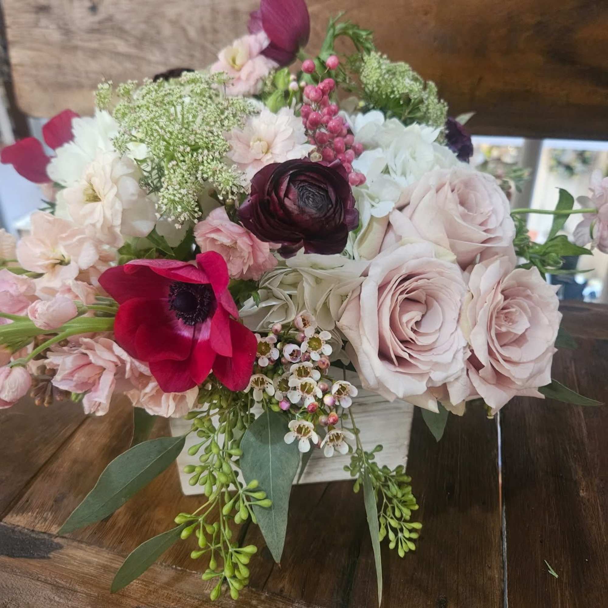 Roses, cymbidium orchids, hydrangea, pink stock, ranunculus, tulips, wax flower, berries, seeded Roses, cymbidium orchids, hydrangea, pink stock, ranunculus, tulips, wax flower, berries, seeded