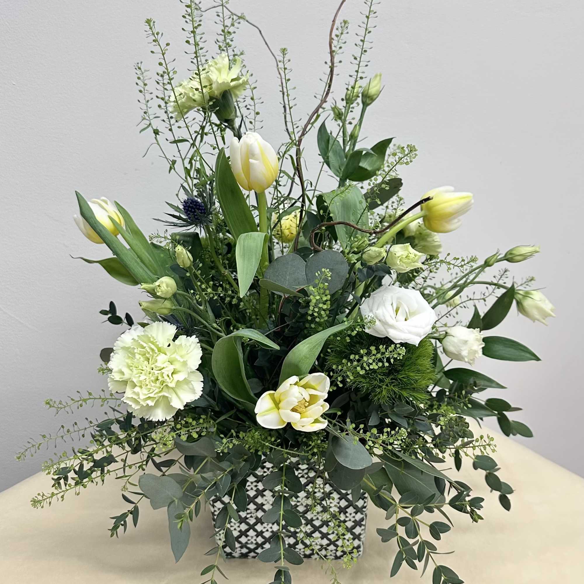 A whimsical mix of green, white and creamy wildflowers arranged in a