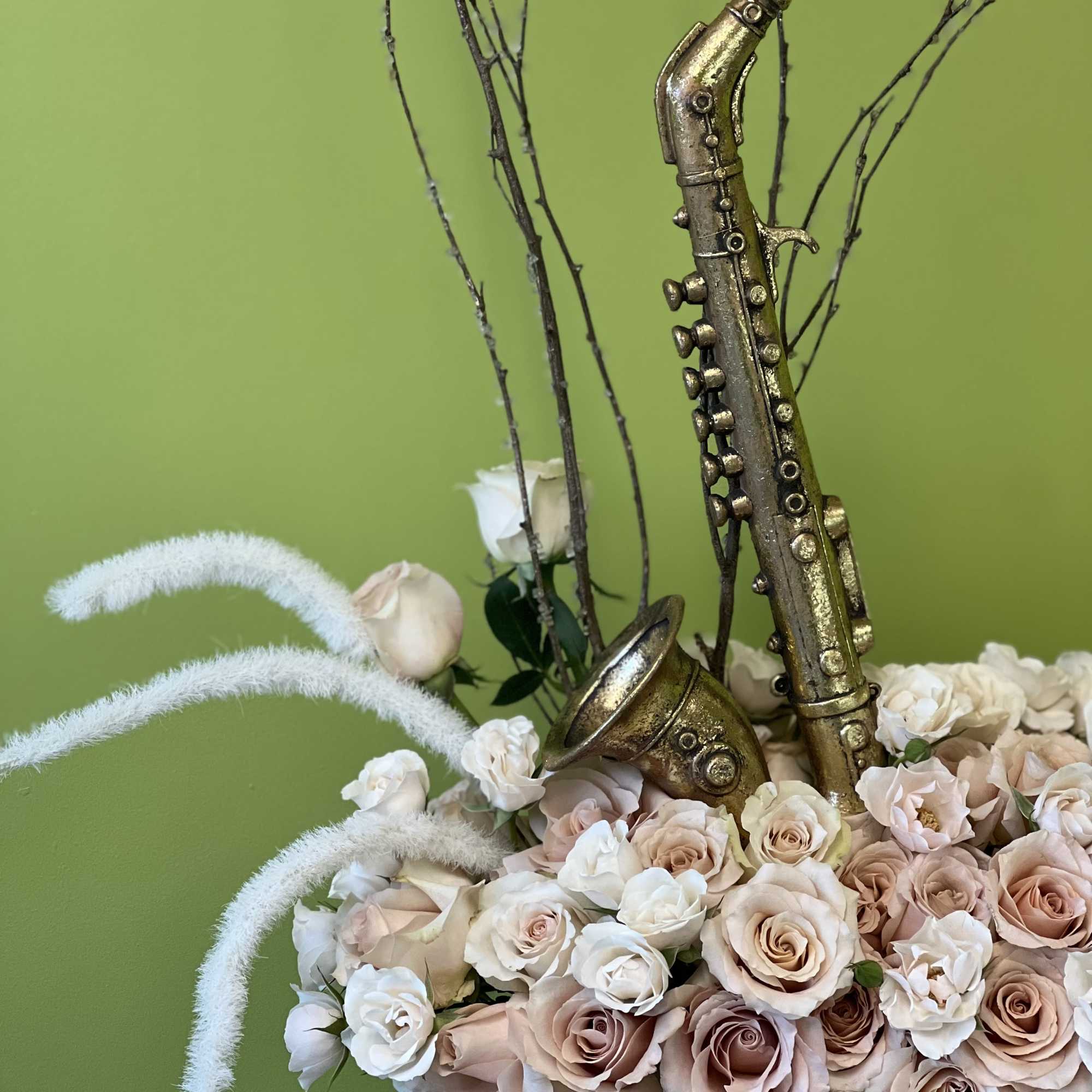 This elegant arrangement features lush blush spray roses and festive Christmas accents