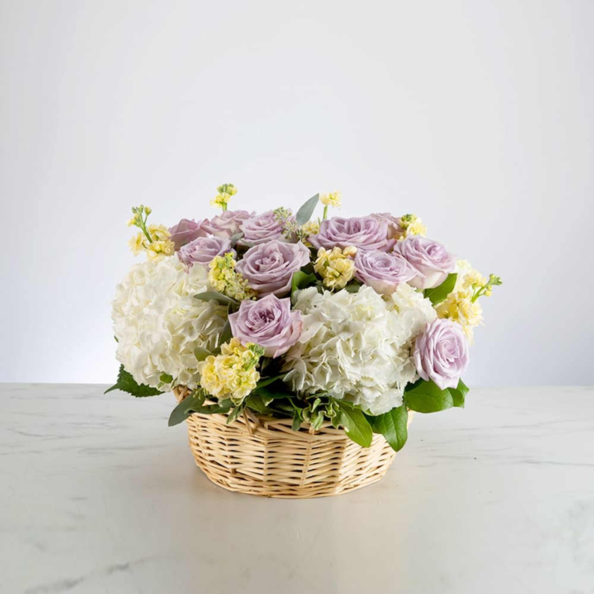 A pastel flowering basket brings peace to any space. Send this beautiful