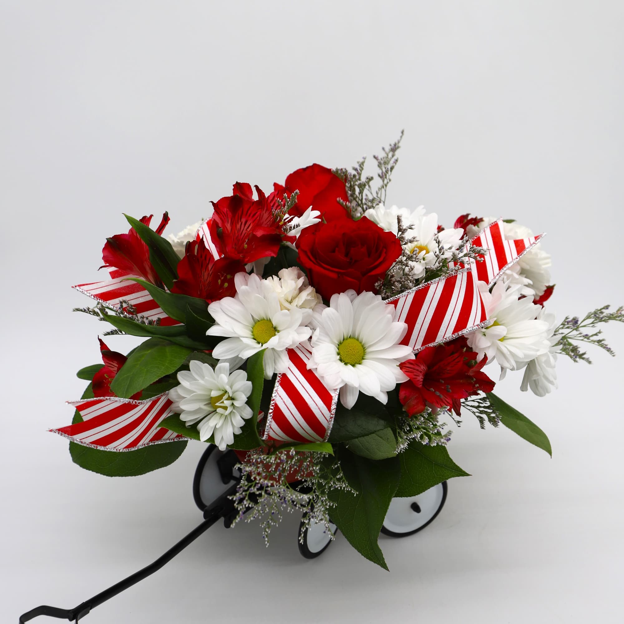 Send your loved ones holiday cheer in a jolly red wagon! This