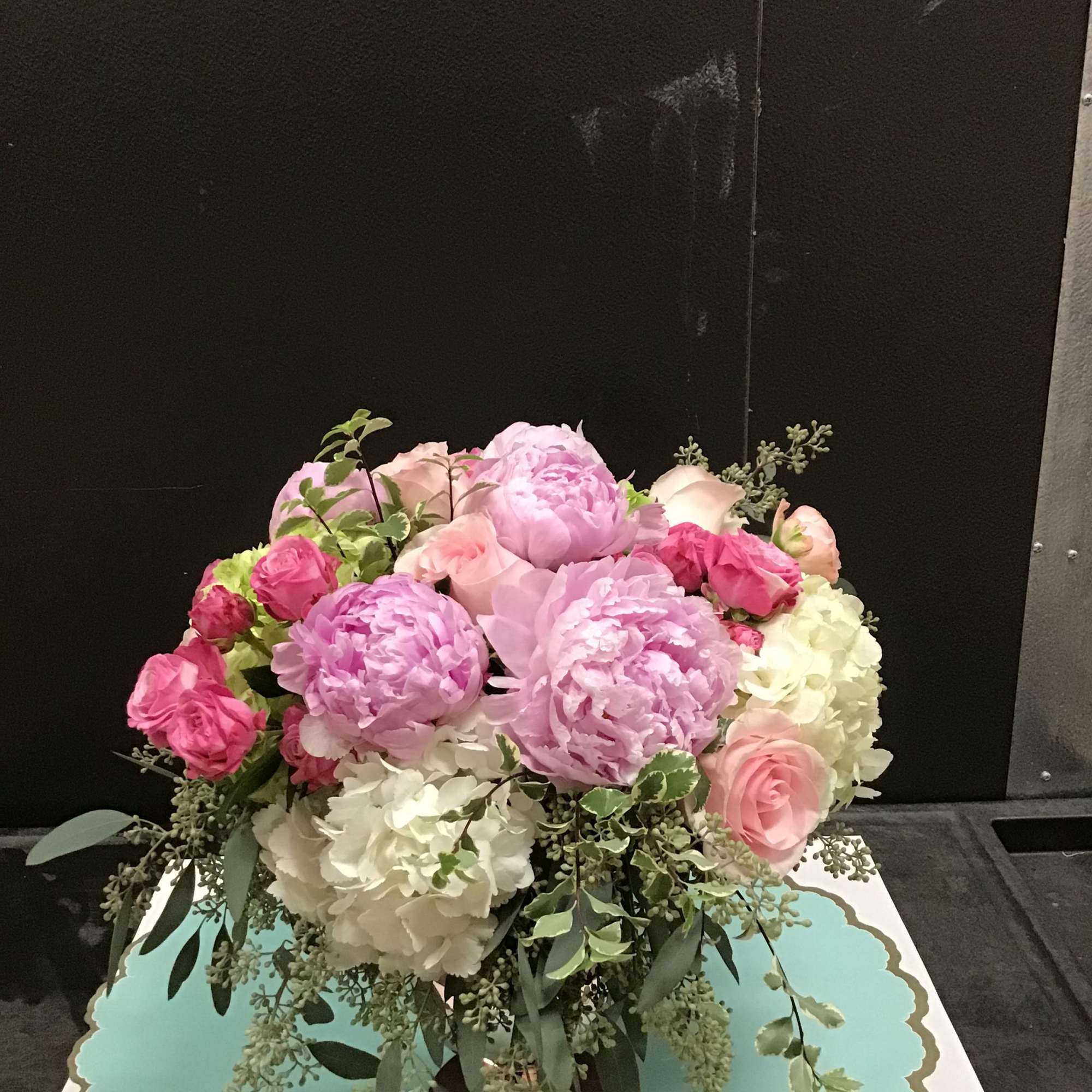 This beautiful elegant arrangement make with peonies , roses, and  hydrangea.