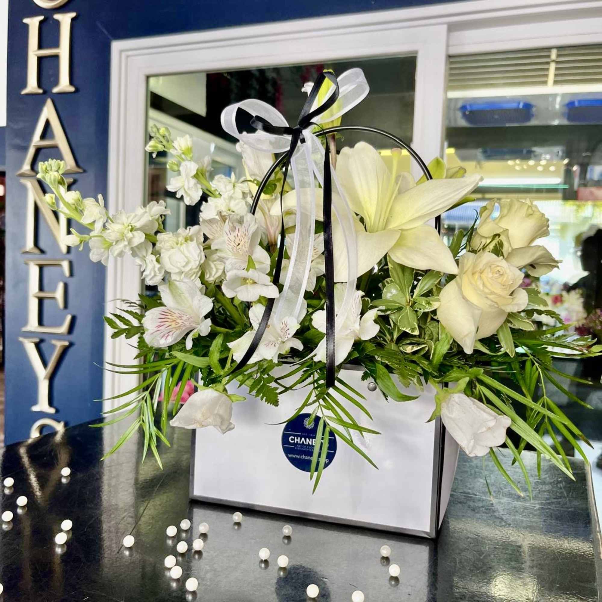 Elevate your occasion with this clear black &amp; white floral expression! Well