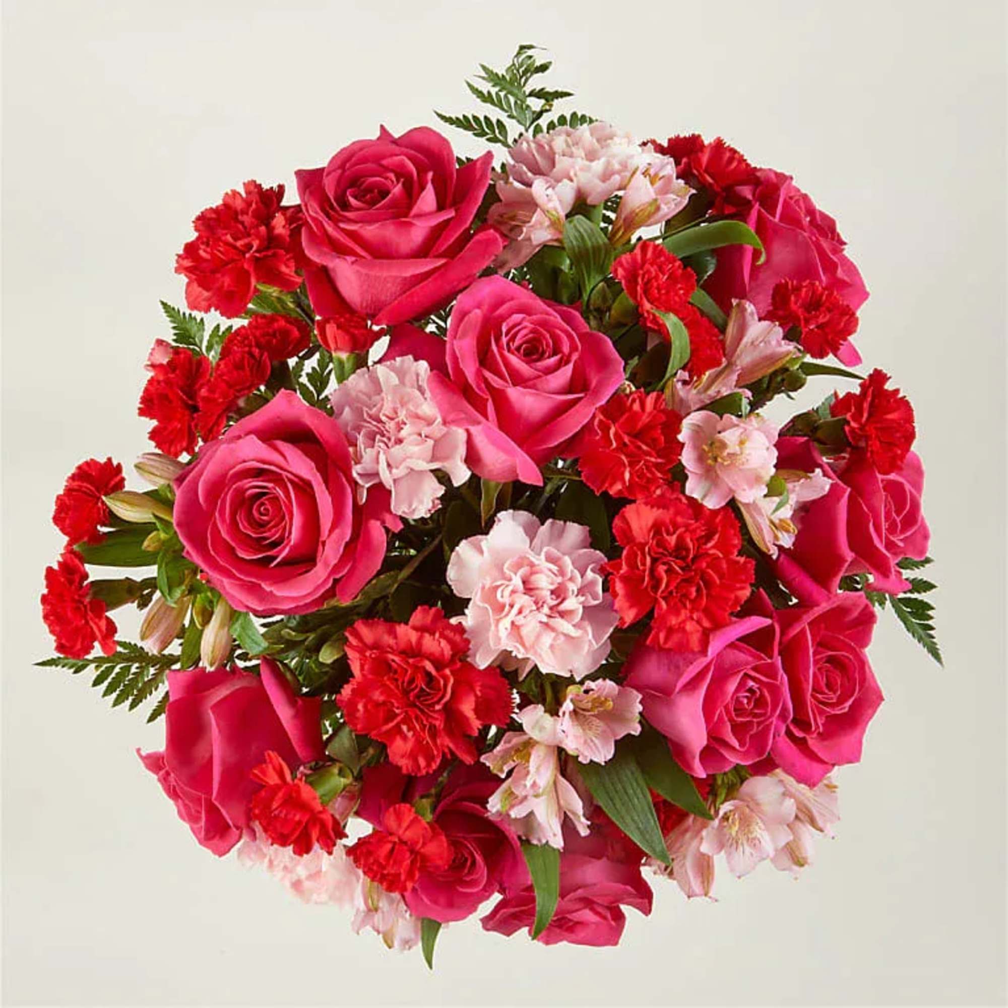 Blushing shades of pink blooms are nestled in lush greens to charm