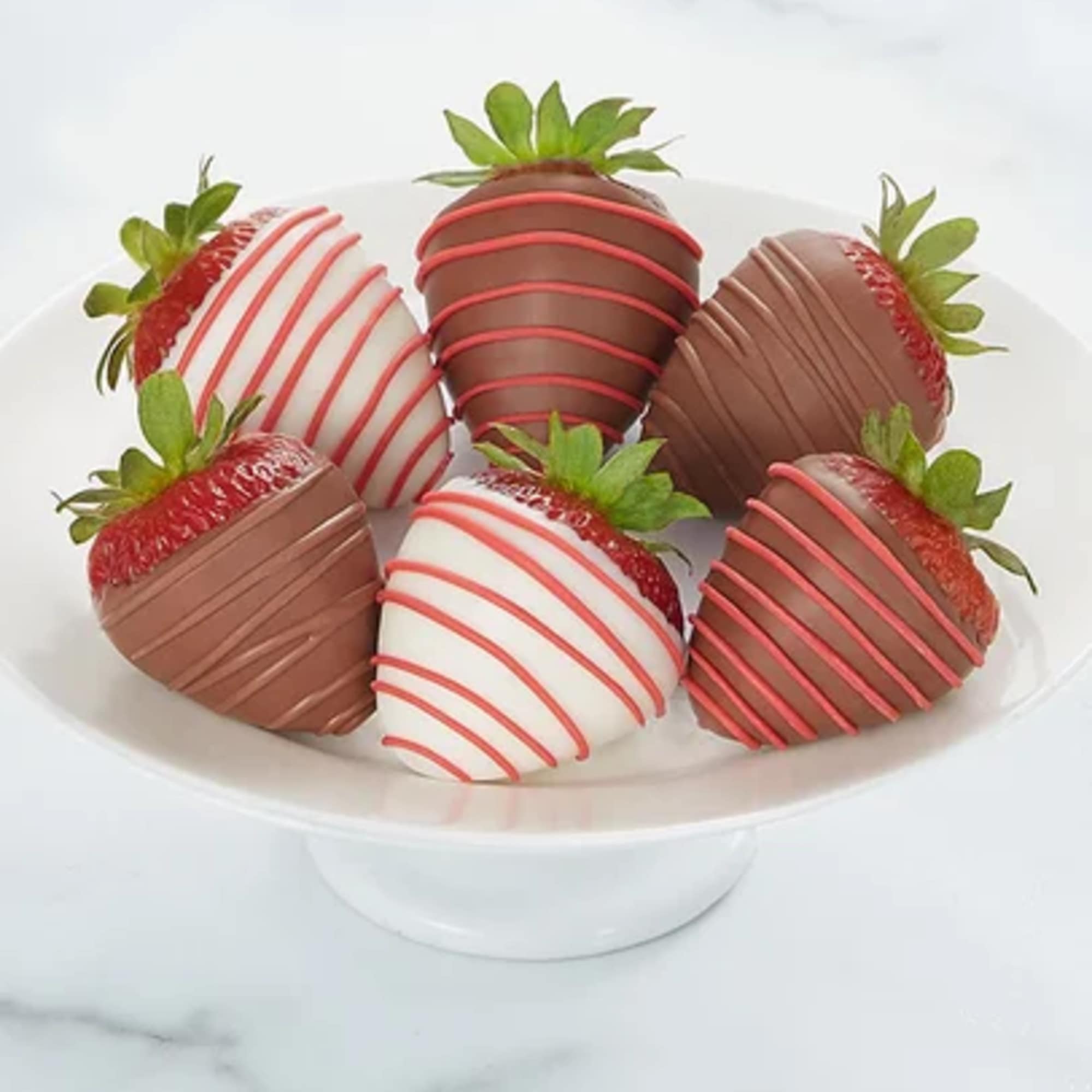 The way to their heart? Our romantic dipped berries, of course. Plump