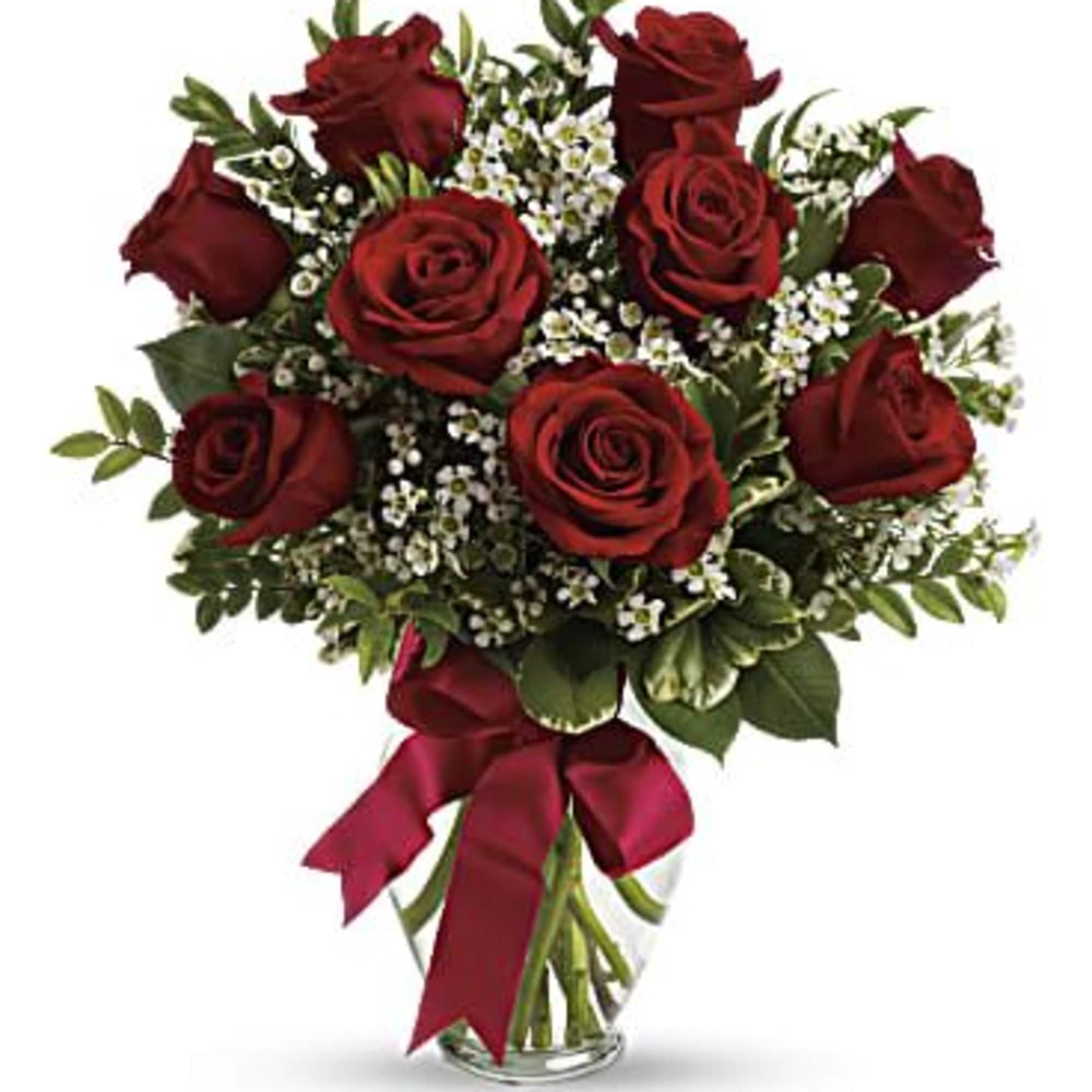 This charming bouquet includes three red roses accented with white waxflower, huckleberry