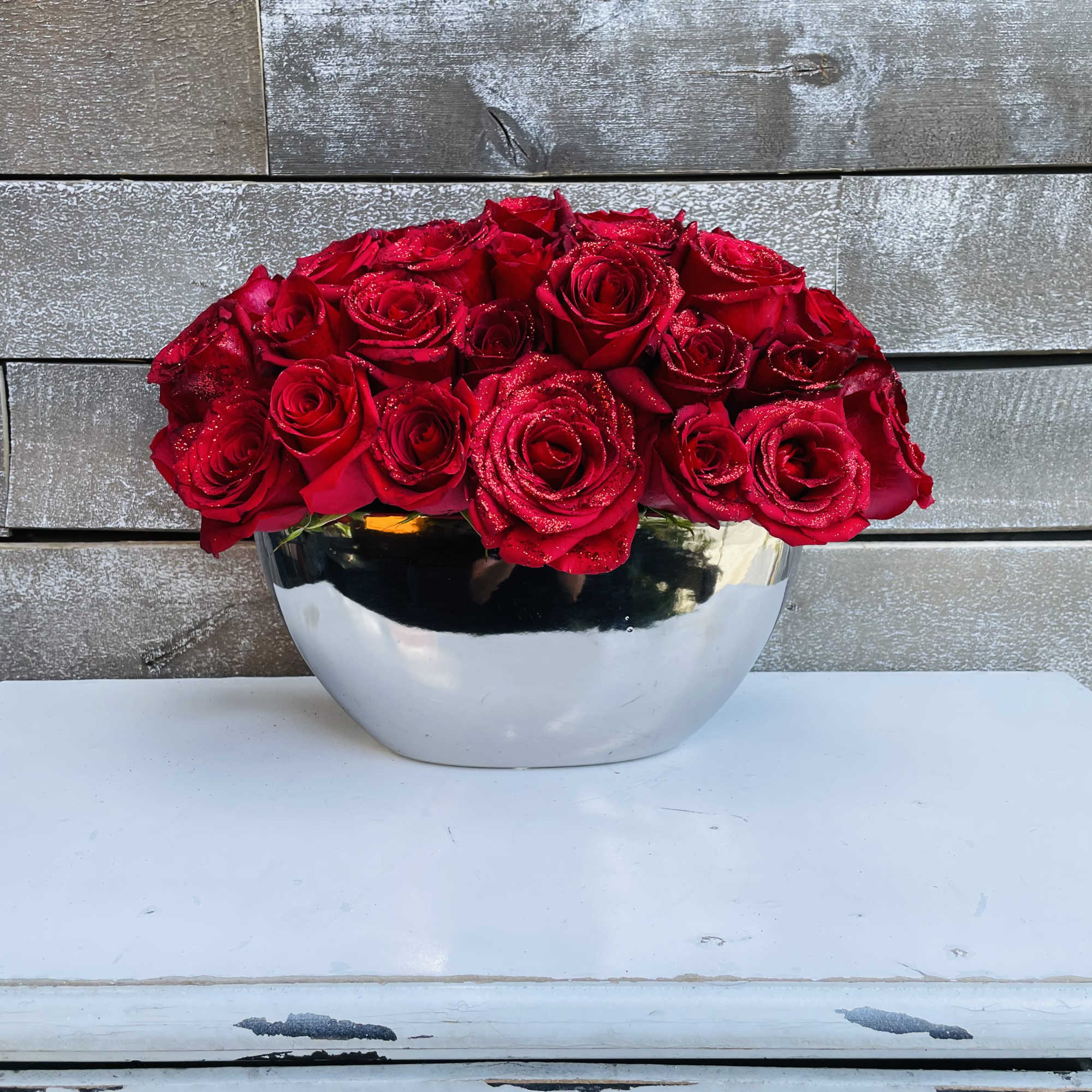 Glitter, red roses, clean silver container, perfection. Glitter, red roses, clean silver container, perfection.