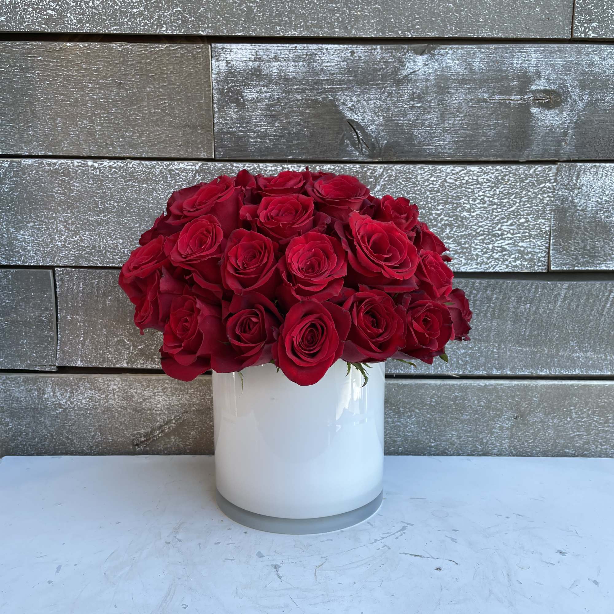 2 dozen red Ecuadorian roses in a white 6x6 cylinder to last 2 dozen red Ecuadorian roses in a white 6x6 cylinder to last