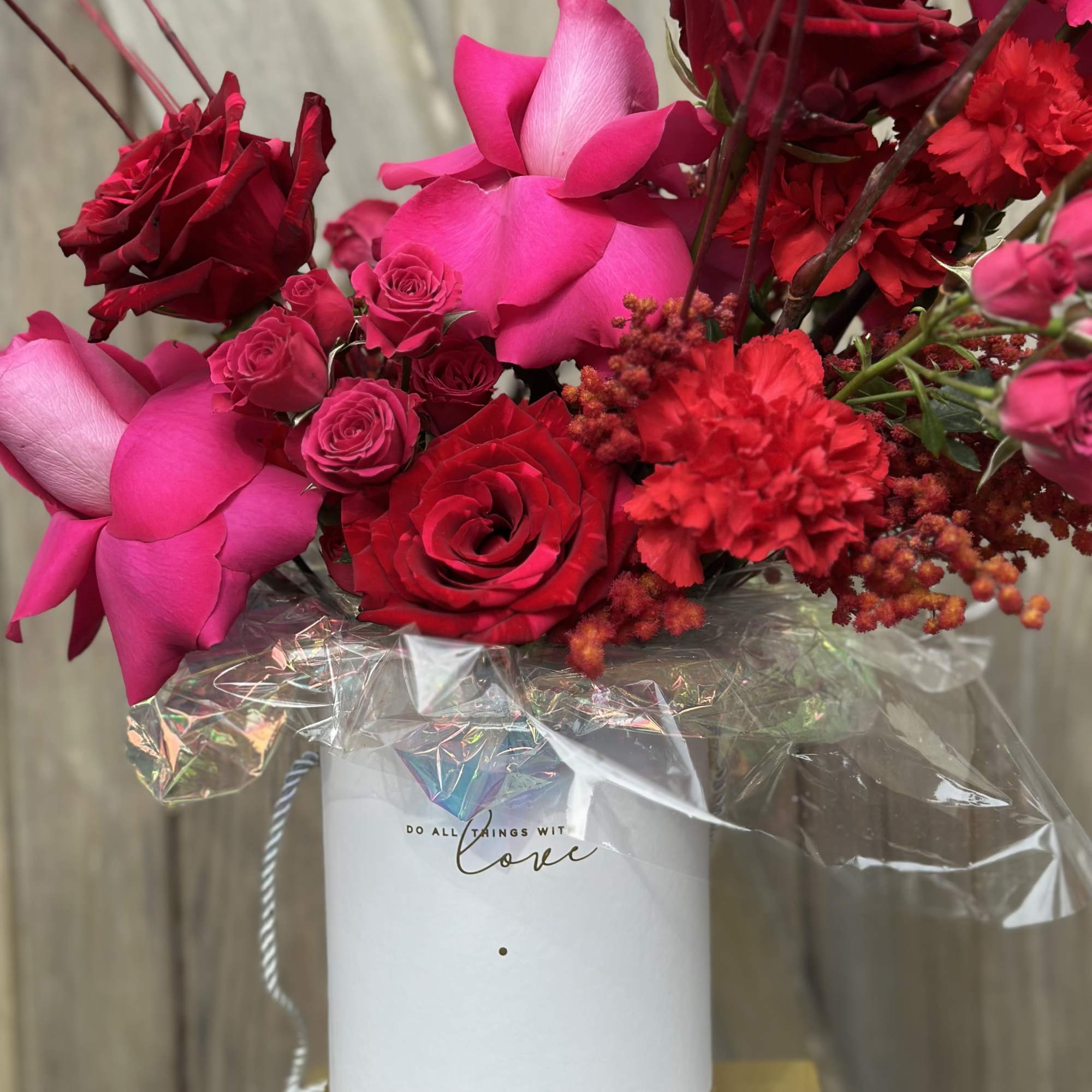 Keepsake Hat box filled with Red and Pink flowers, sure to delight