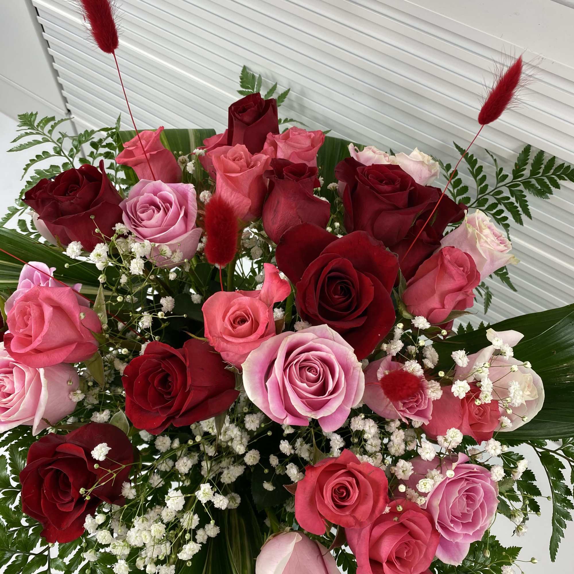 A rich mix of 2 dozen red roses and 1 dozen pink