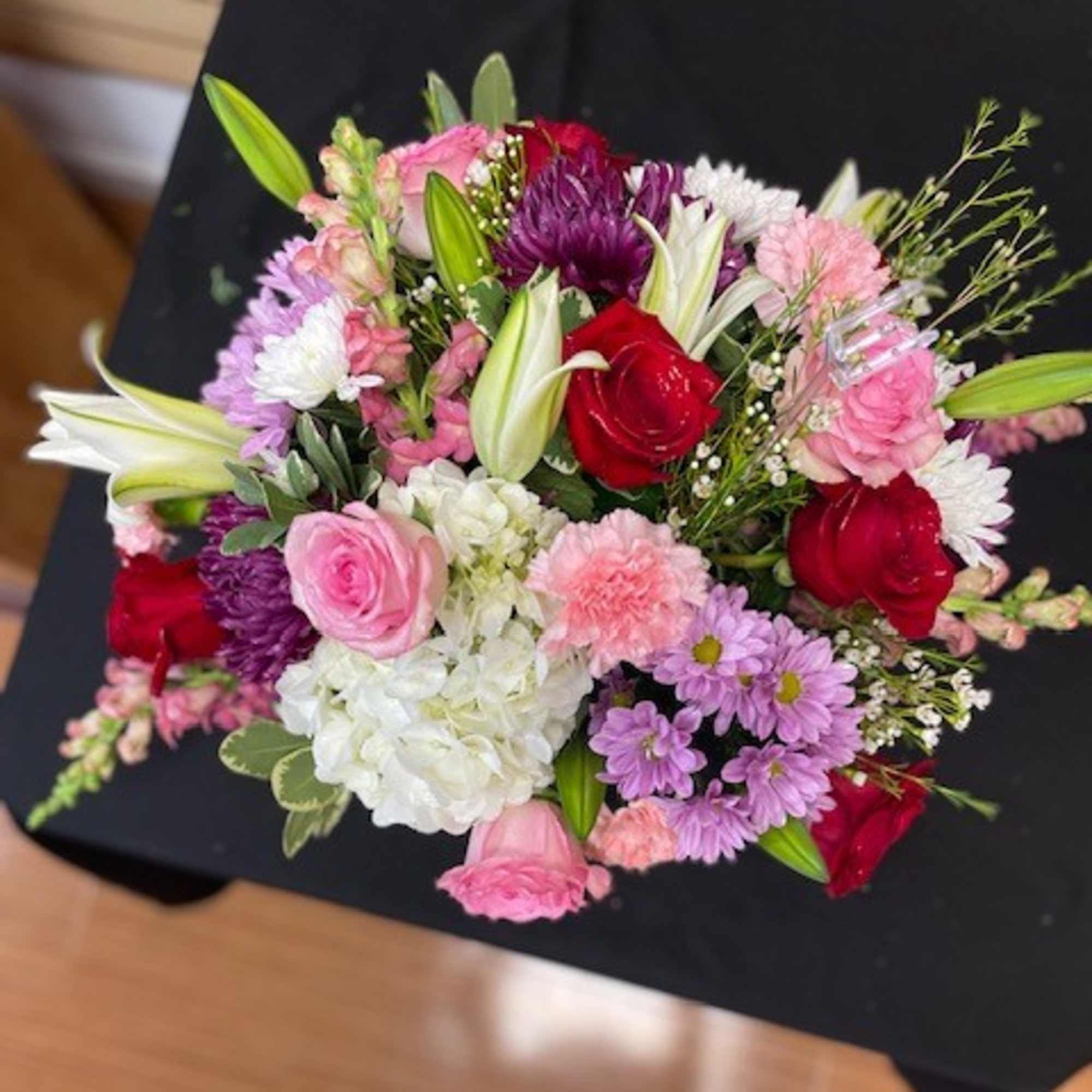 Mixed cut with red roses, pink roses, white hydrangea, lavender daisies, white