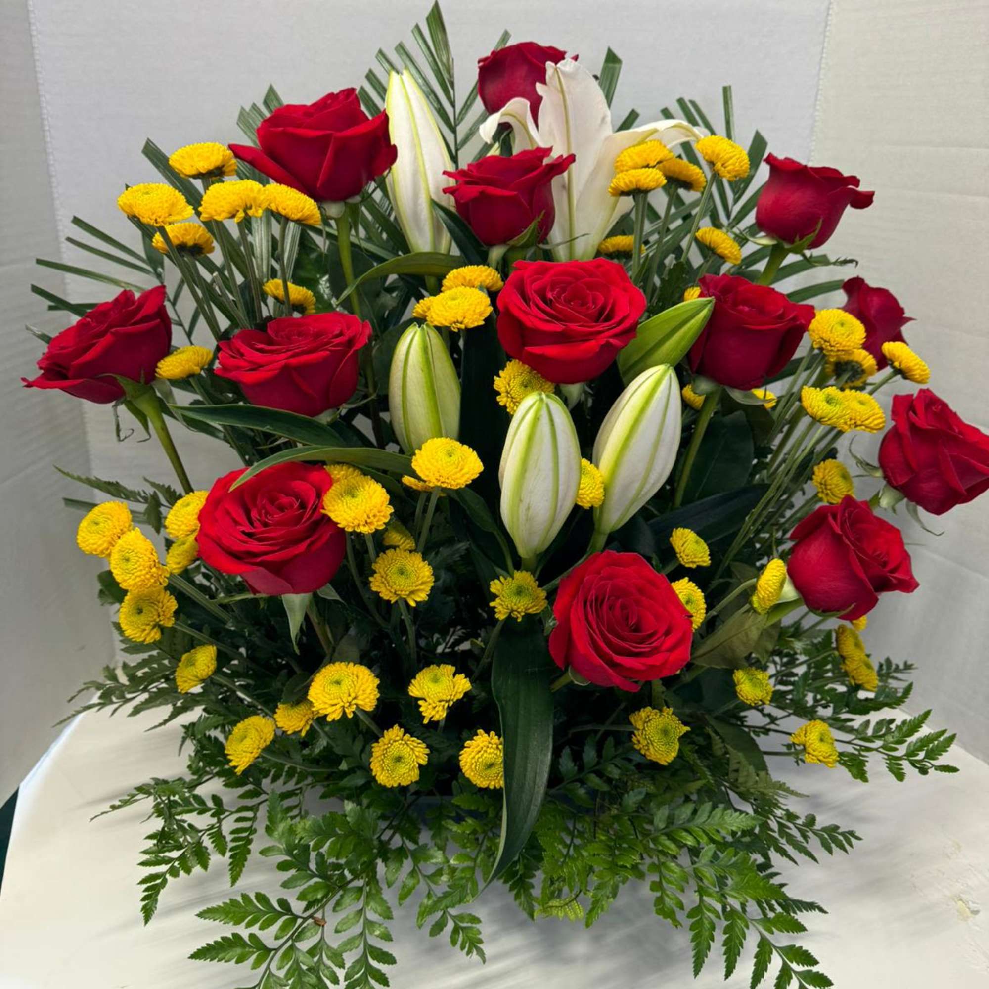 An arrangement with lilies and 18 roses simply the best for anyone