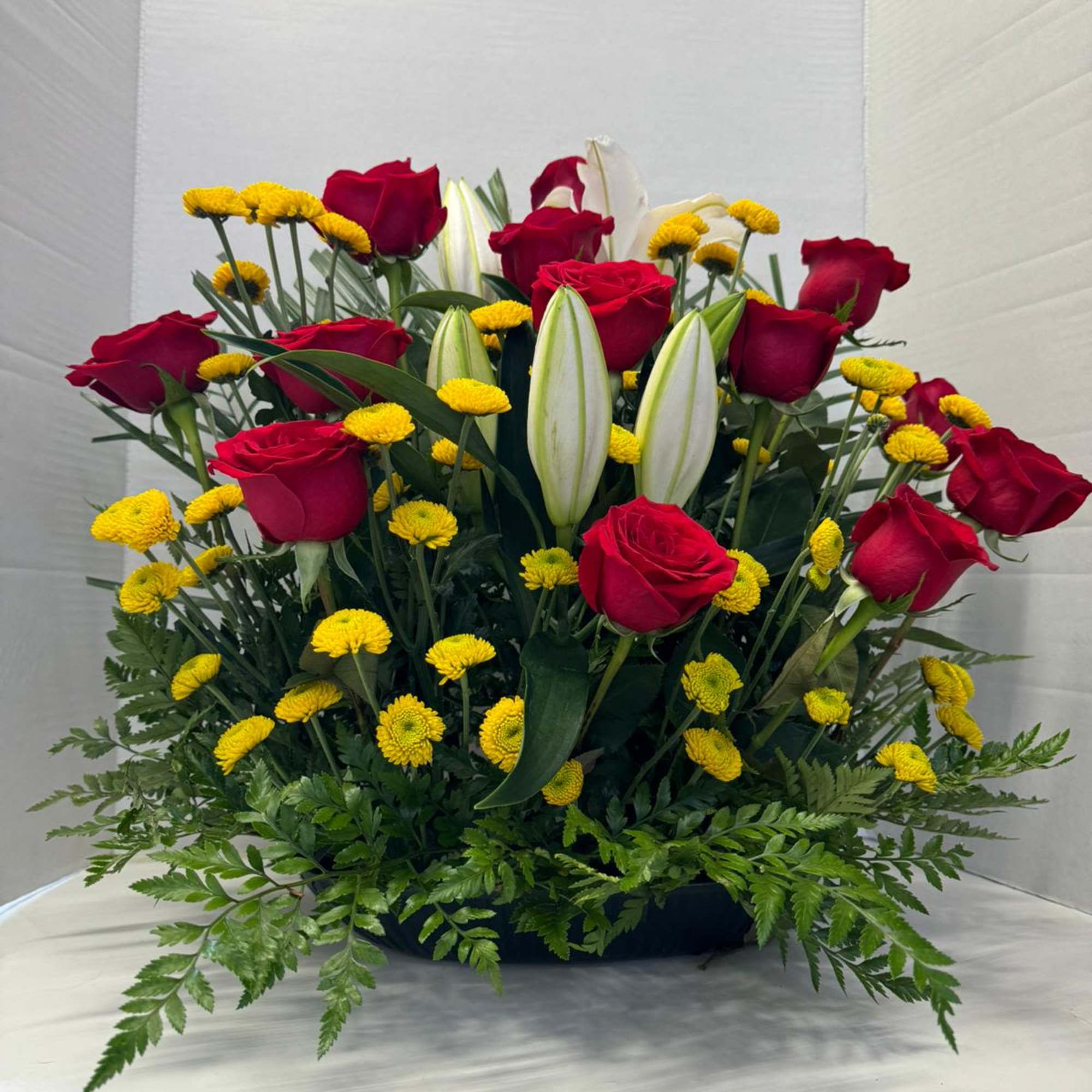 An arrangement with lilies and 18 roses simply the best for anyone