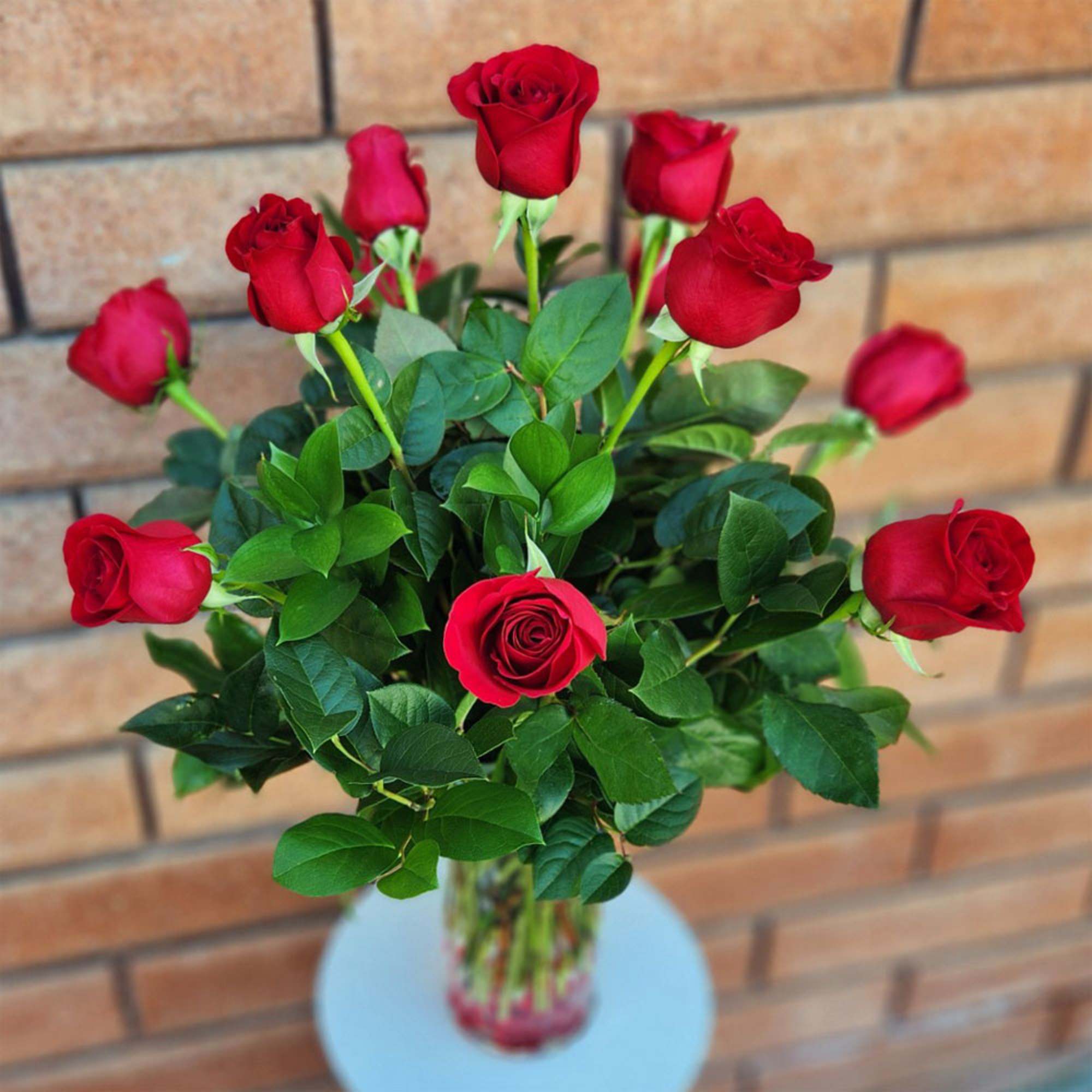 These passionate long stem red roses are professionally hand arranged in organic