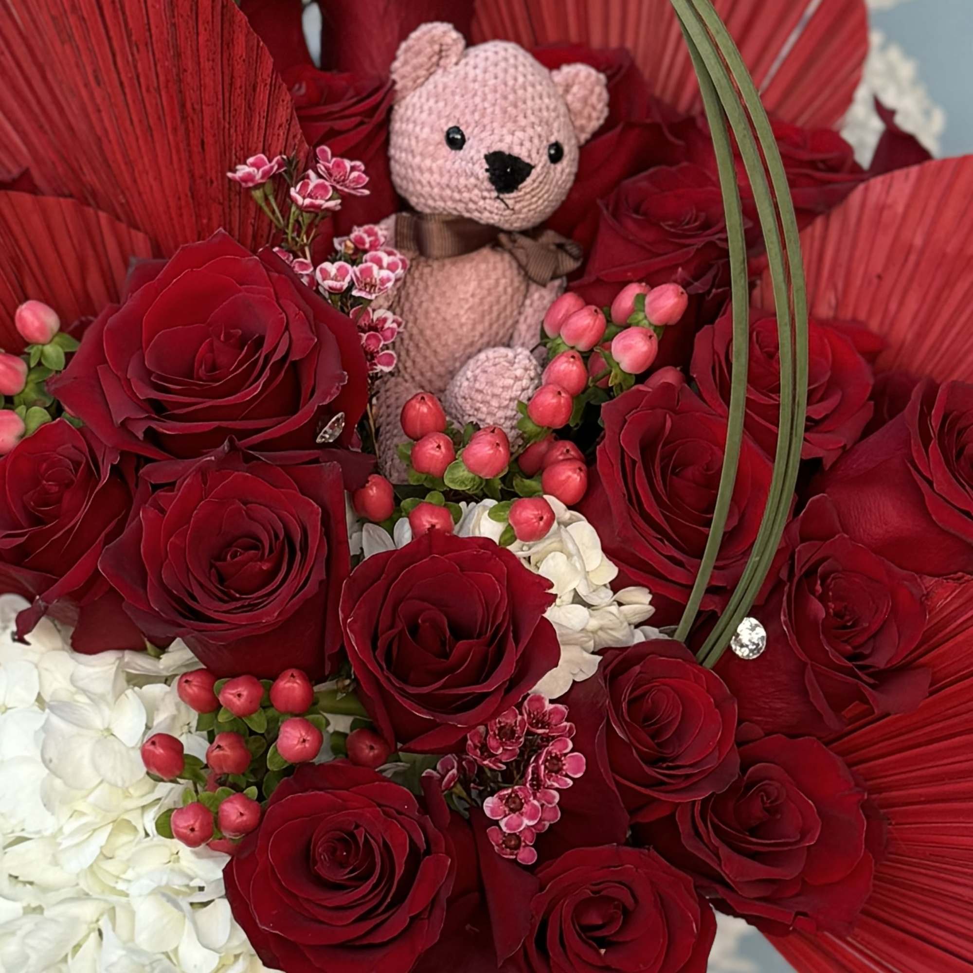 2 Dozen beautifully designed in a nice red vase with red dried