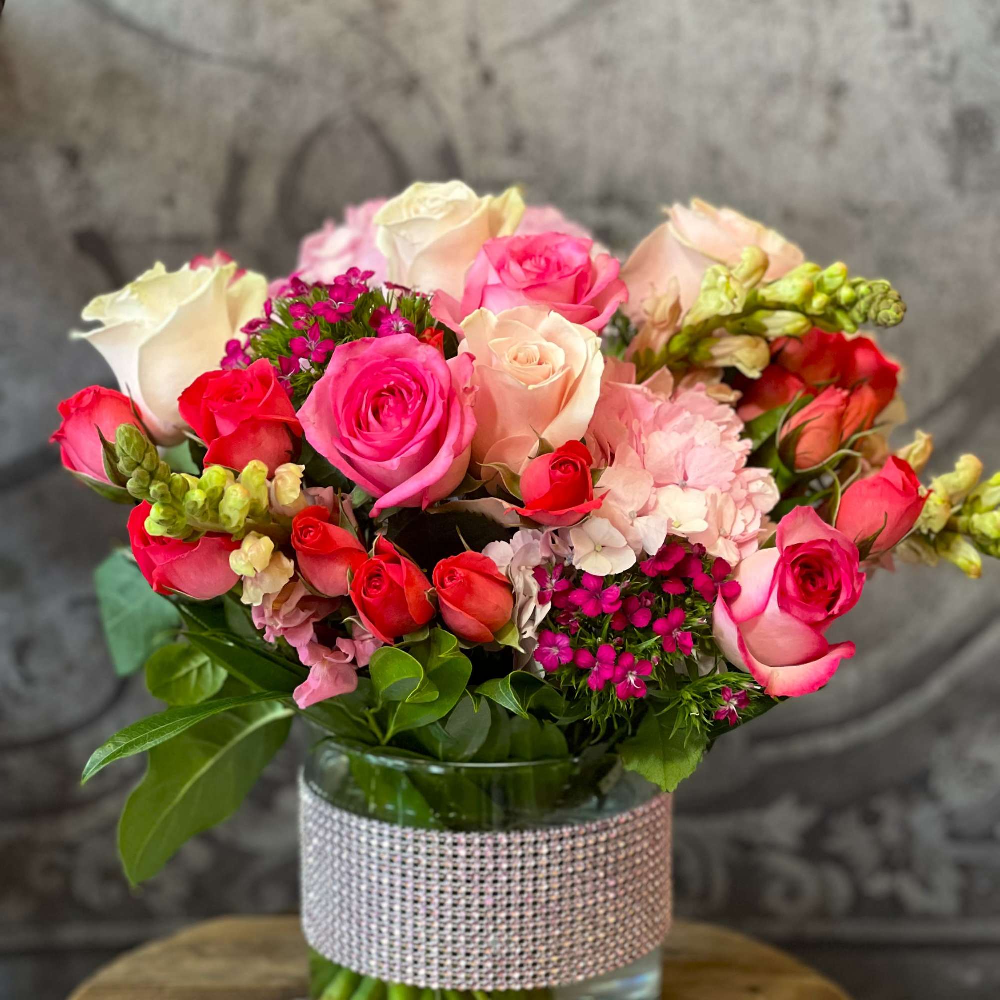 We just love this beautiful arrangement of roses, spray roses, hydrangeas, and