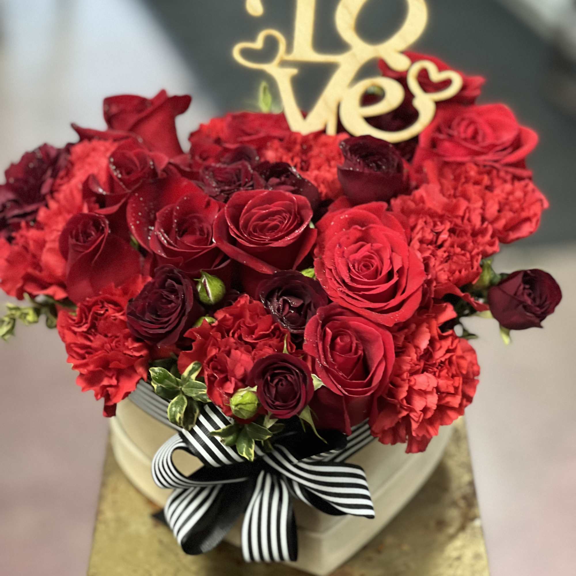 Simply adorable, red flowers, arranged in headbox decorated with romantic ribbon tied