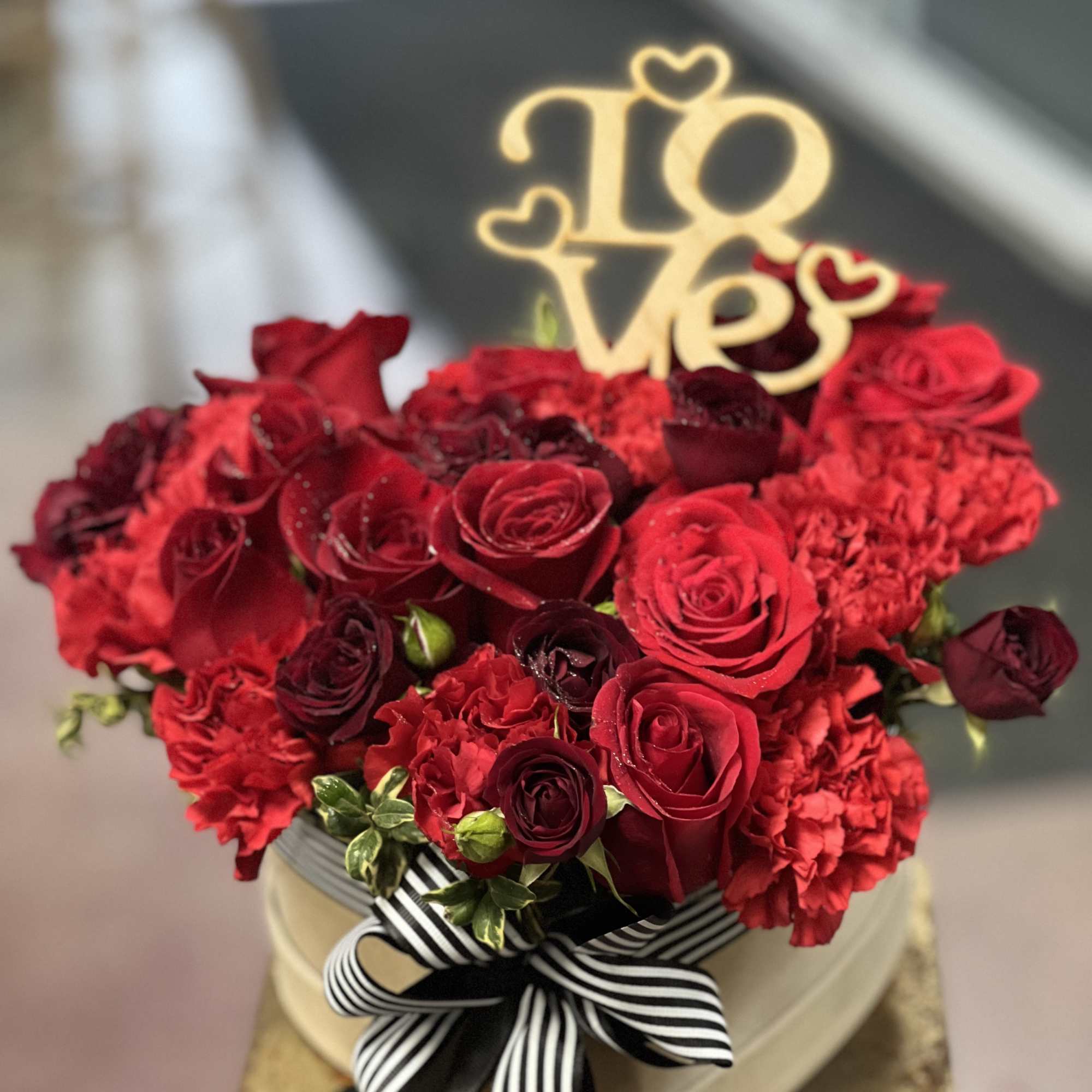 Simply adorable, red flowers, arranged in headbox decorated with romantic ribbon tied