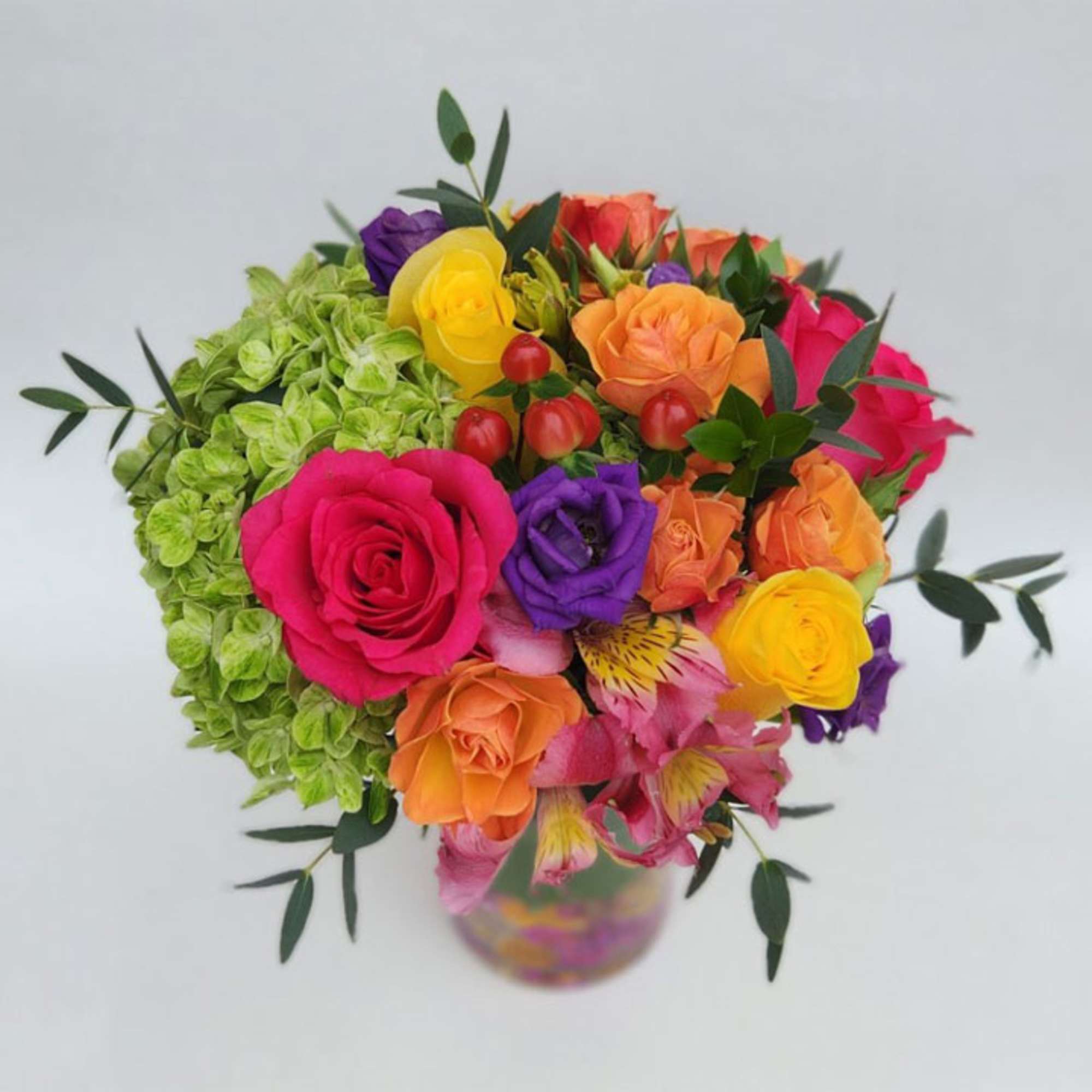 Our vivid bouquet features roses, hydrangea, lisianthus, alstroemerias, hypericum berries, eucalyptus and