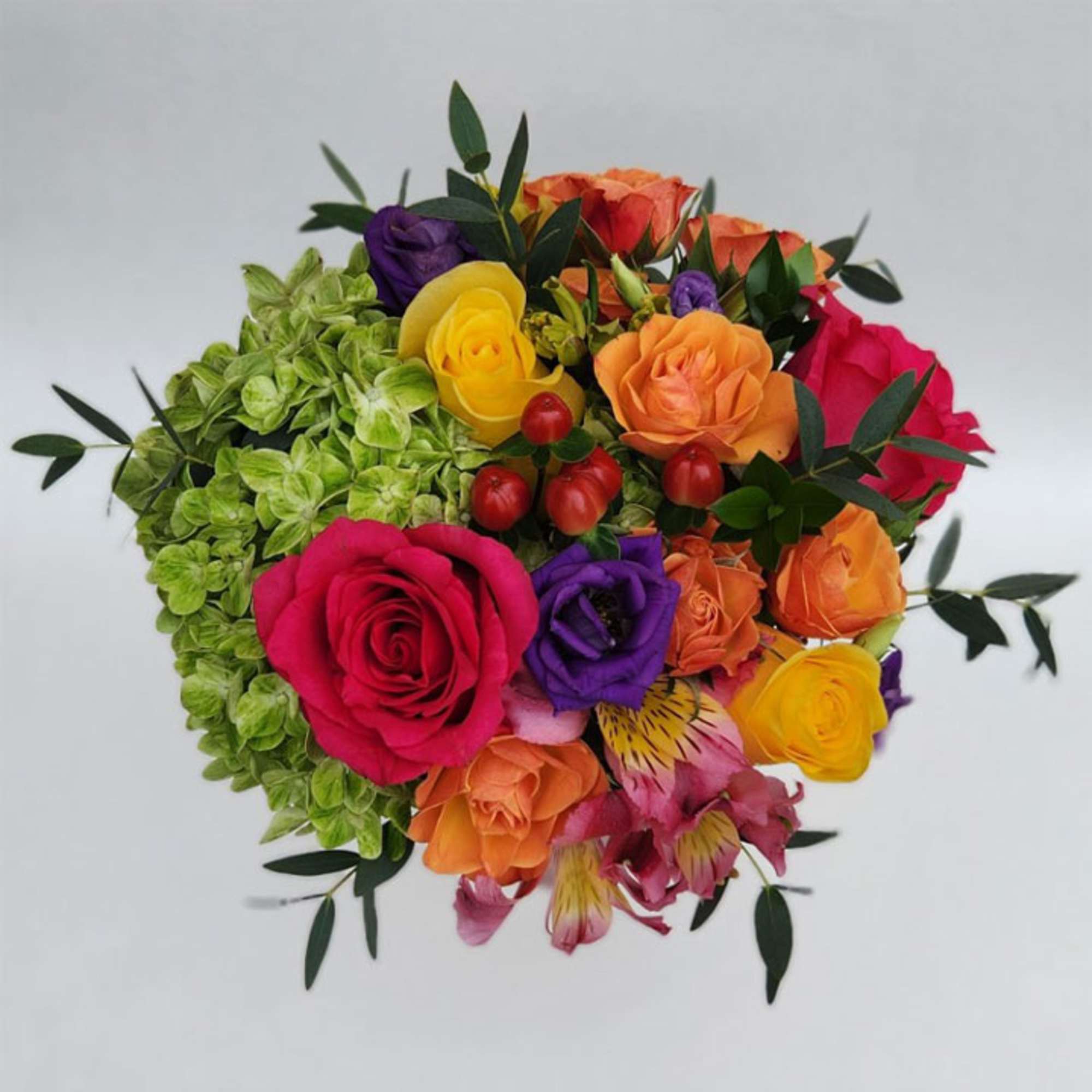 Our vivid bouquet features roses, hydrangea, lisianthus, alstroemerias, hypericum berries, eucalyptus and