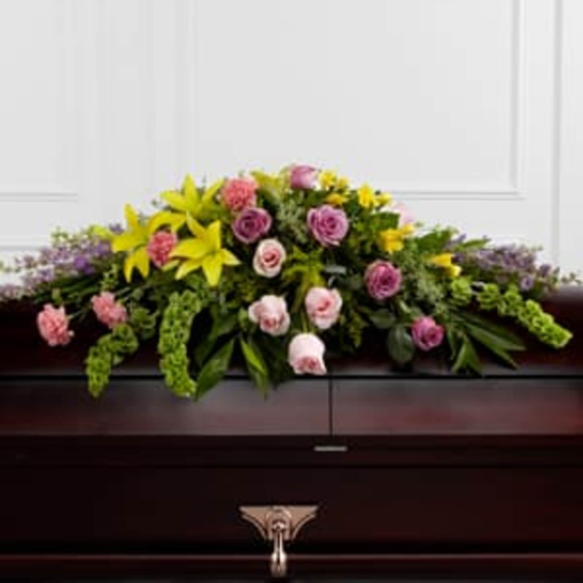  The FTD&reg; Forever Beloved&trade; Casket Spray beautifully illuminates the atmosphere of