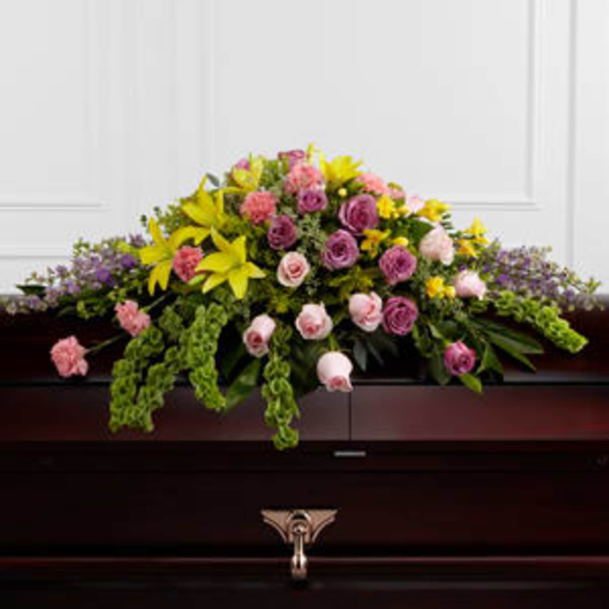  The FTD&reg; Forever Beloved&trade; Casket Spray beautifully illuminates the atmosphere of