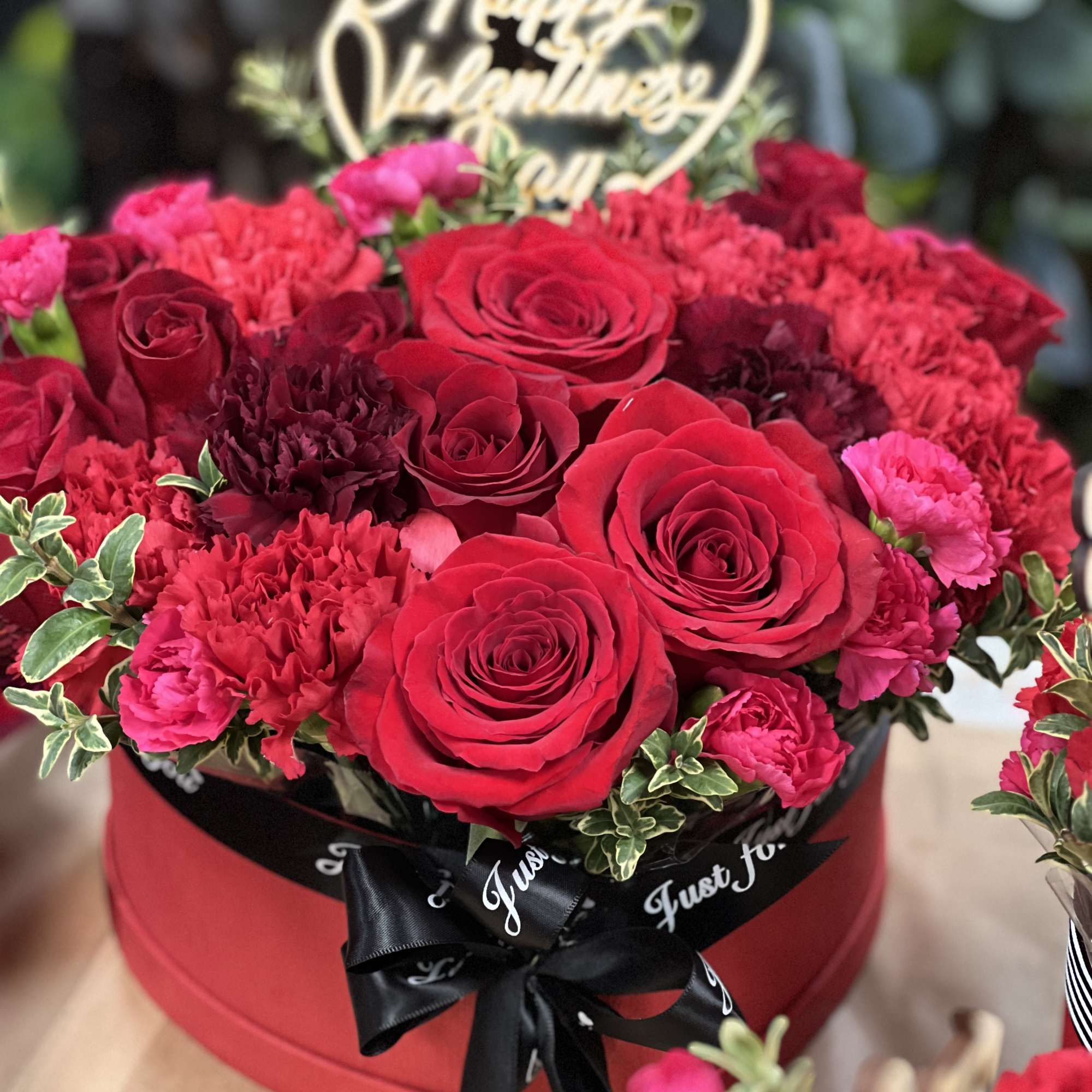 Adorable mixture of red flowers, including red roses in the romantic flower