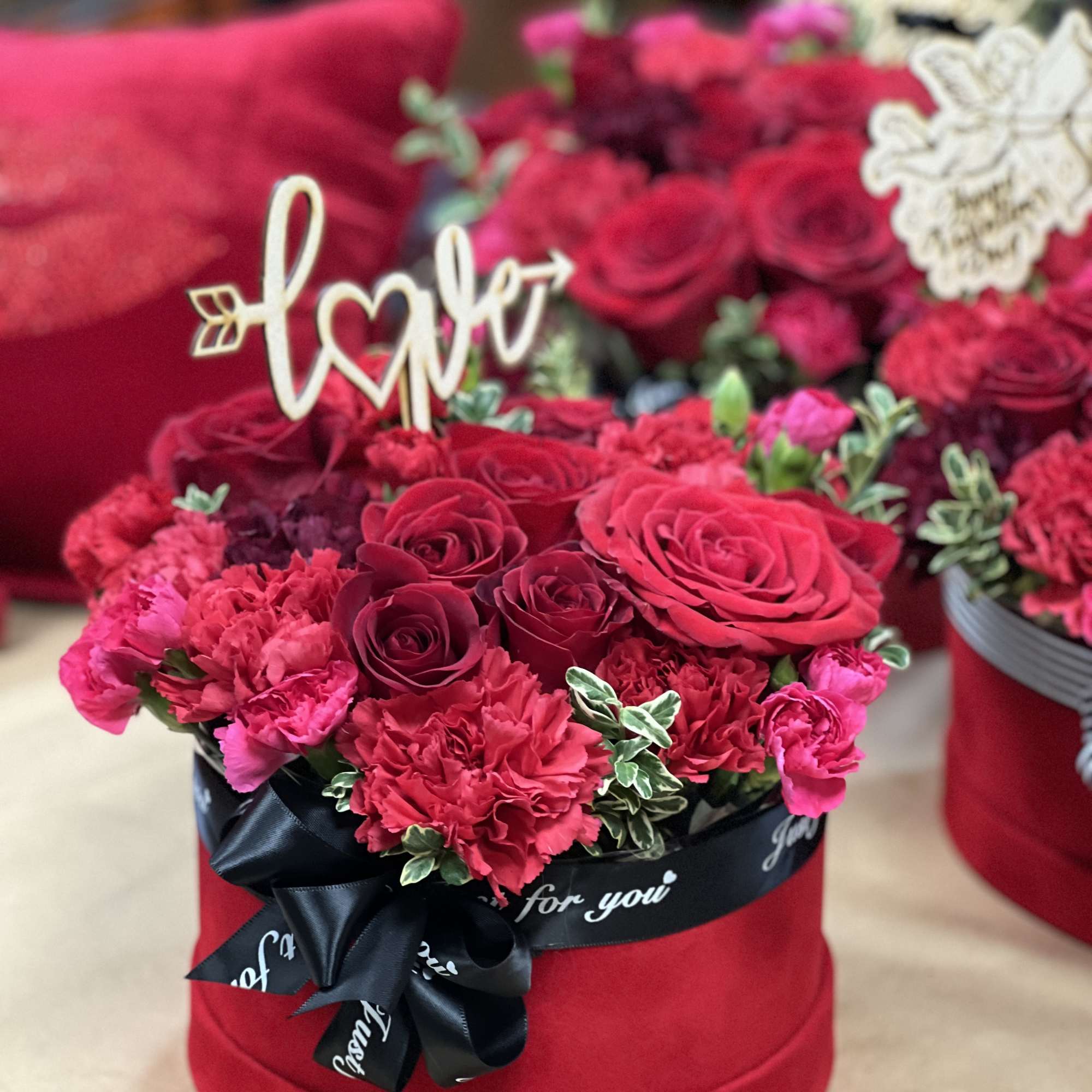 Adorable mixture of red flowers, including red roses in the romantic flower