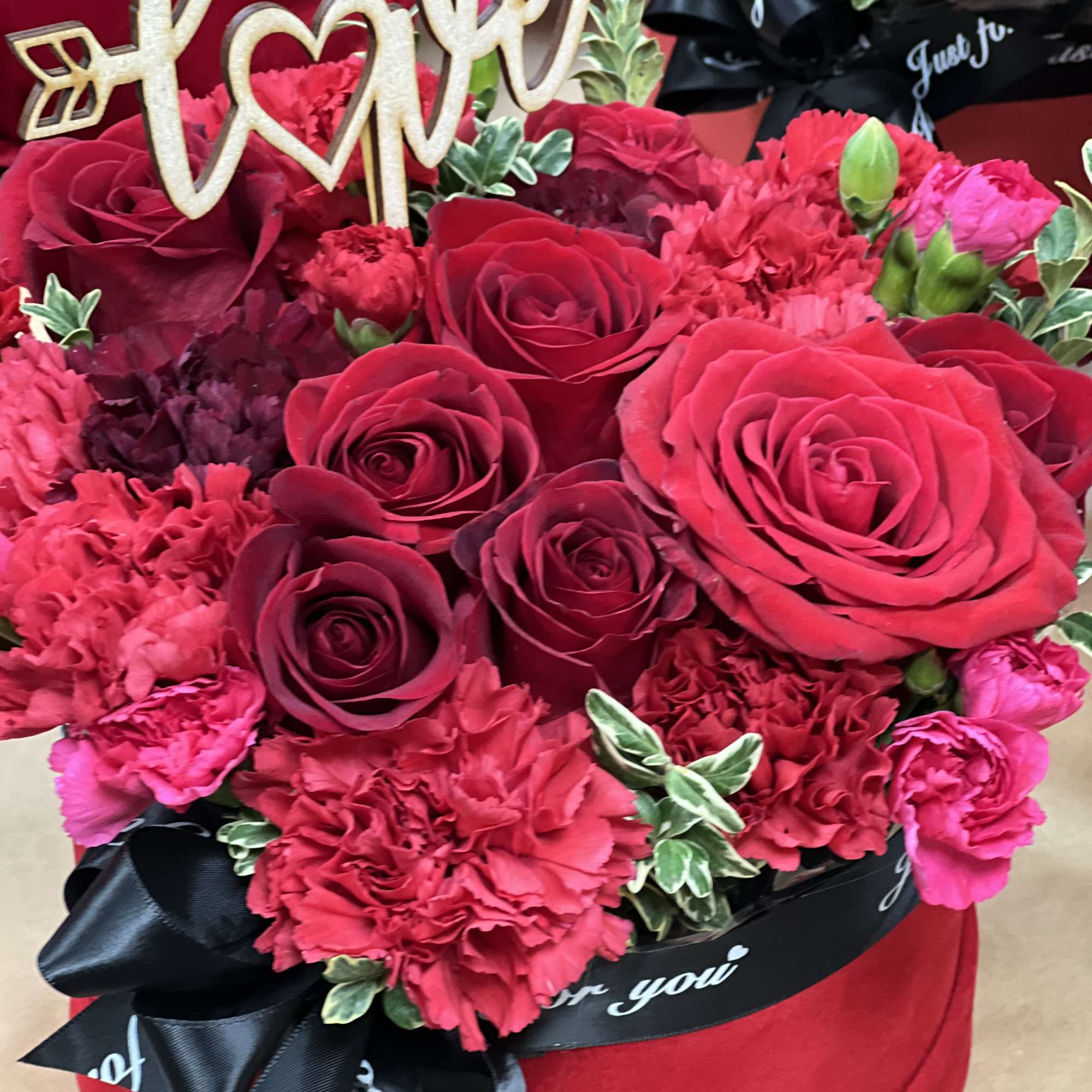 Adorable mixture of red flowers, including red roses in the romantic flower