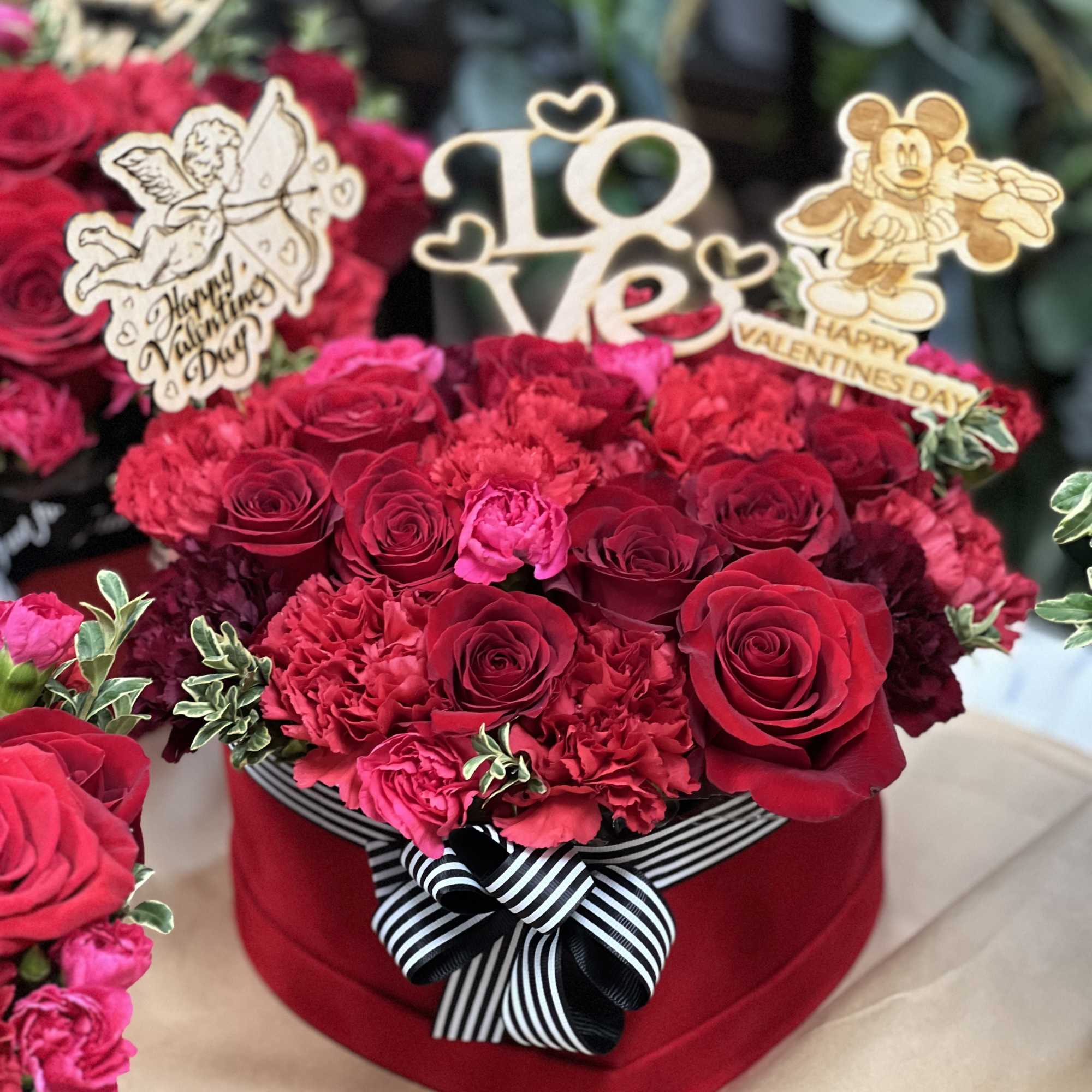 Adorable mixture of red flowers, including red roses in the romantic flower