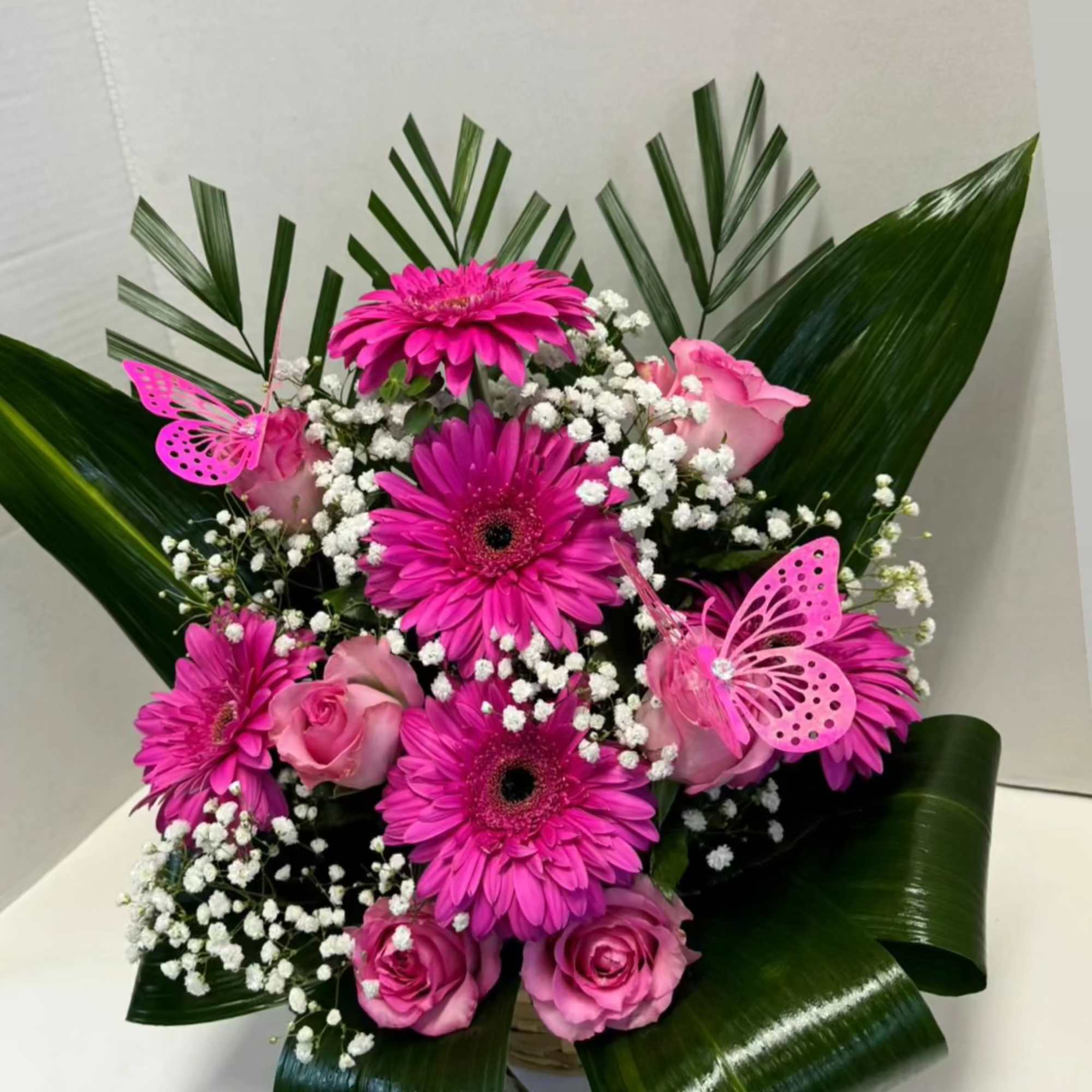 We designed the pink arrangement with roses and gerberas, taking care of